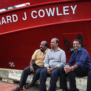 Siva Mehanathan, left to right, Suhapiramam Annalingam, Baskaran Nadarajah and Puvanendran Shanmuga sit in front of the Coast Guard ship Leonard J Cowley in St. John's, Newfoundland on Thursday, Aug. 11, 2016. 30 years ago, today, 155 Tamil Refugees were rescued off the coast of Newfoundland. (Paul Daly/CP)