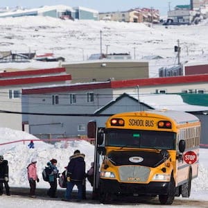 Nunavut's former language commissioner is expressing anger over proposed changes to the Education Act, passed in 2008, that promises all Inuit children guaranteed access to bilingual education by 2019 so as to produce graduates equally fluent in Inuktut and English. Students board a school bus at the Nakasuk Elementary School in Iqaluit, Nunavut, in a March 30, 2009, file photo. THE CANADIAN PRESS/Nathan Denette