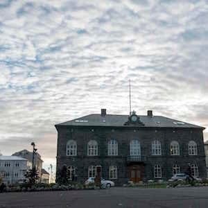 A man walks past the Althingi Parliament building in Reykjavik, Iceland on October 24, 2017.
Iceland on October 28, 2017 holds its second snap election in just a year after multiple scandals ensnaring its leaders, a sign of no end in sight to crisis in a nation with a thriving economy fuelled by booming tourism. / AFP PHOTO / Halldor KOLBEINS / TO GO WITH AFP STORY by Ilgin KARLIDAG (Photo credit should read HALLDOR KOLBEINS/AFP/Getty Images)