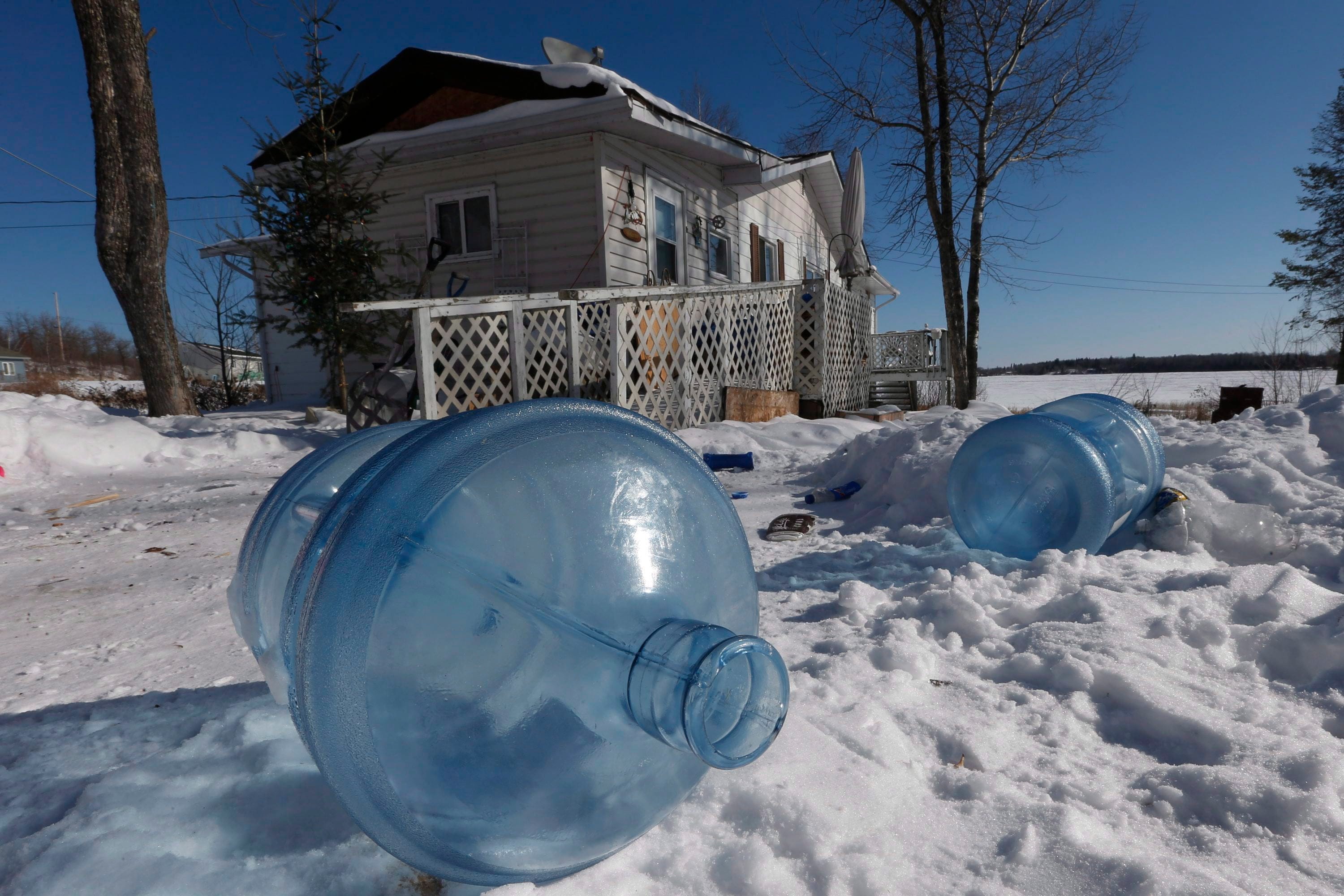 Empty 20 litre water bottles sit outside Laura Green's house waiting for pickup and refilling Wednesday, February 25, 2015. The Shoal Lake community, despite supplying water to the city of Winnipeg, is under a boil water advisory and lacks year round road access. THE CANADIAN PRESS/John Woods