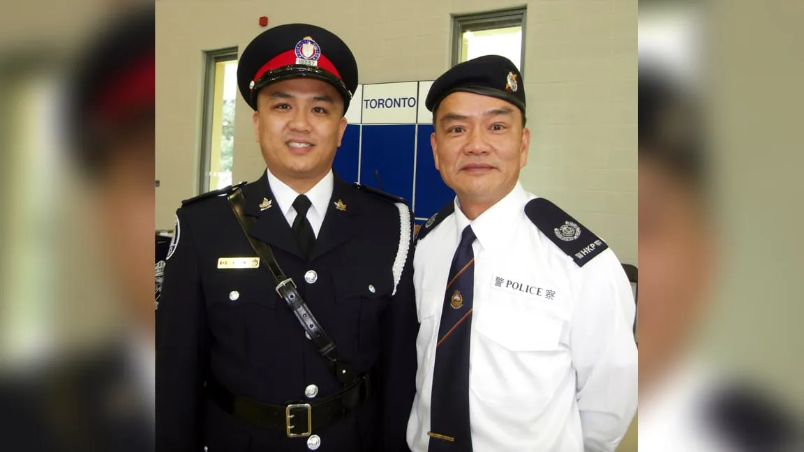 Const. Kevin Lam posing with his father David Lam at his police graduation. (Handout/David Lam)