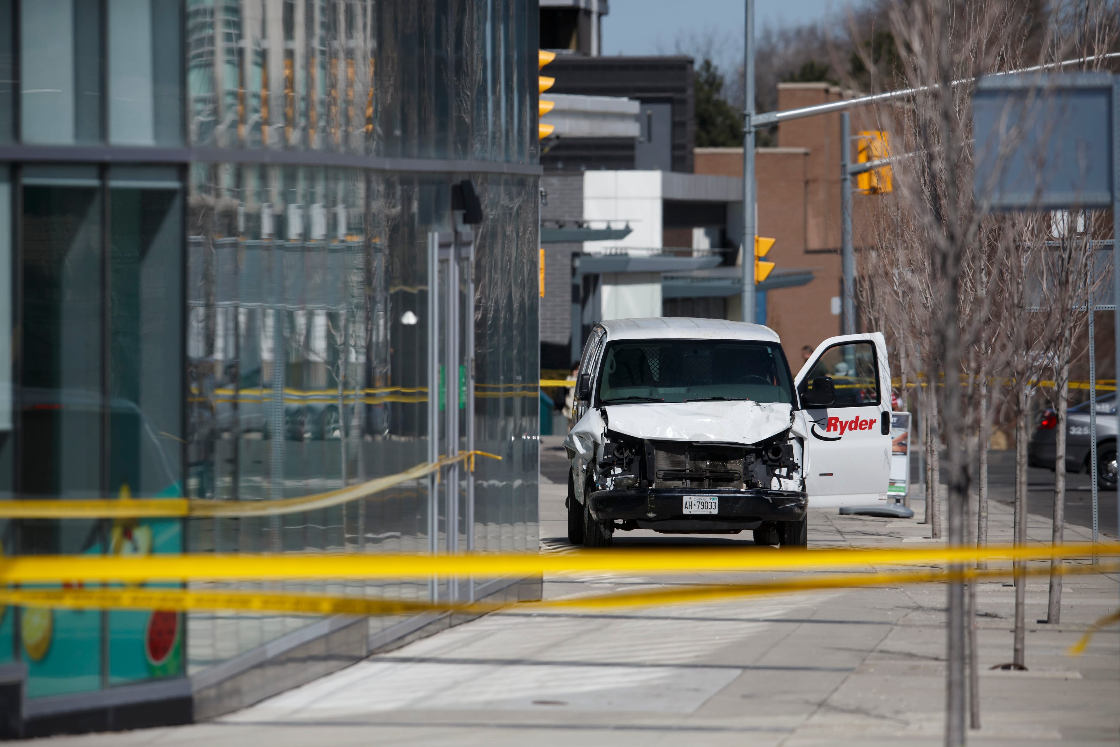 Police inspect a van involved in a collision that killed 10 people at Yonge St. and Finch Ave. on April 23, 2018 in Toronto.
(Photo by Cole Burston/Getty Images)