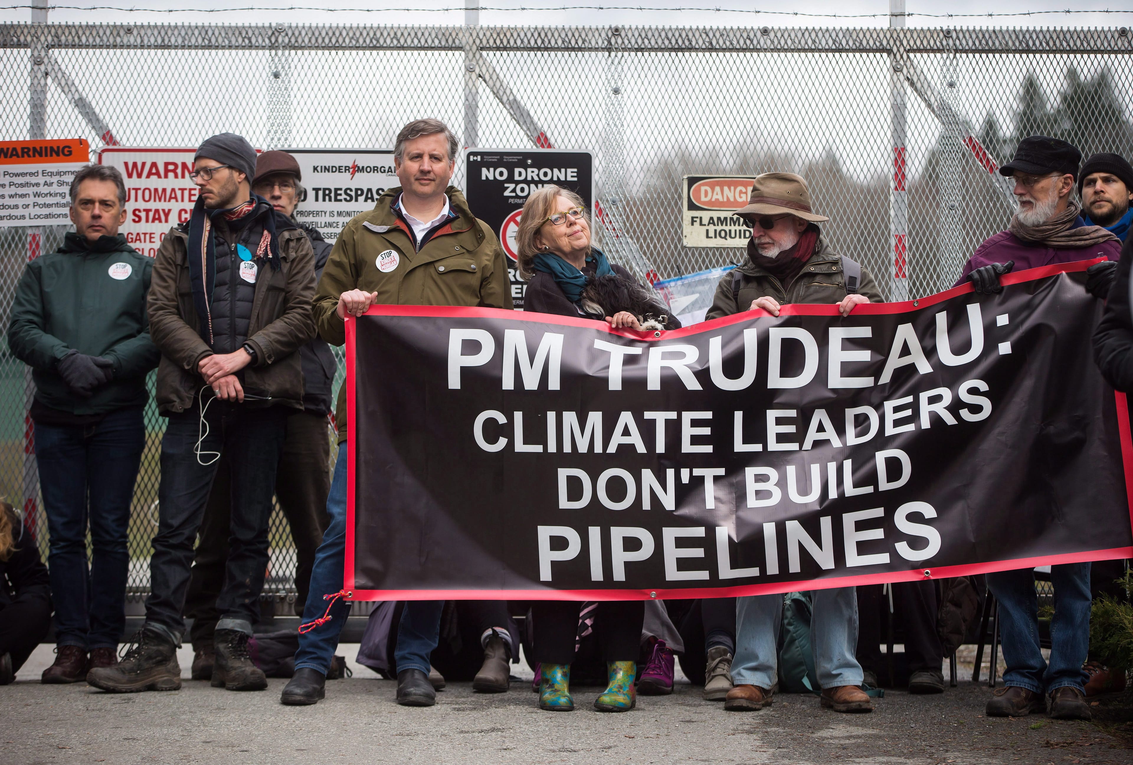 Federal Green Party Leader Elizabeth May
(centre) and NDP MP Kennedy Stewart (centre, left) stand with protesters before they were arrested outside Kinder Morgan's facility in Burnaby, B.C., on Friday March 23, 2018. (THE CANADIAN PRESS/Darryl Dyck)