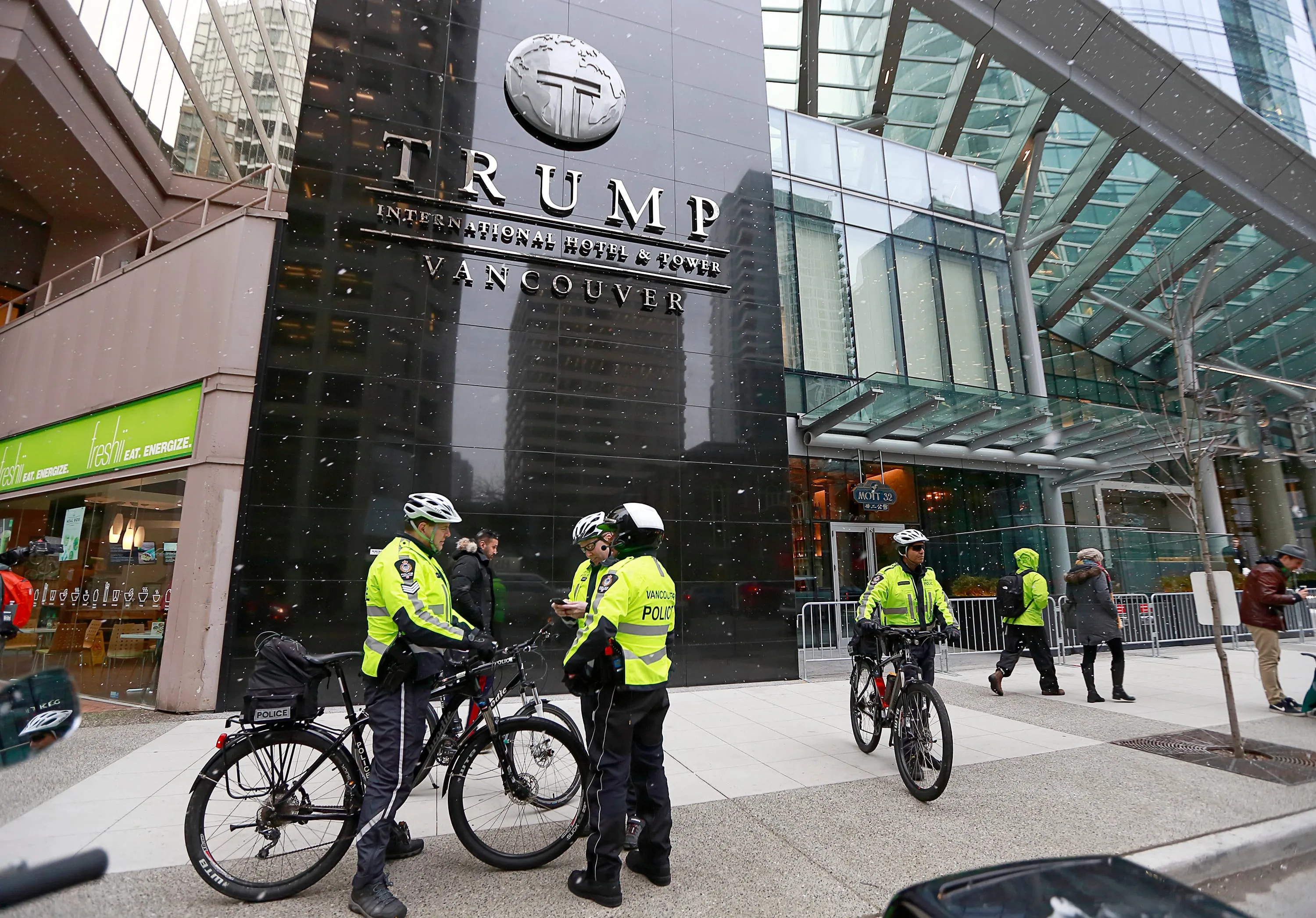Police officers gather outside the front of the Trump International Tower & Hotel during the official opening on February 28, 2017 in Vancouver, Canada. The tower is the Trump Organization's first new international property since Donald Trump assumed the presidency. (Photo by Jeff Vinnick/Getty Images)