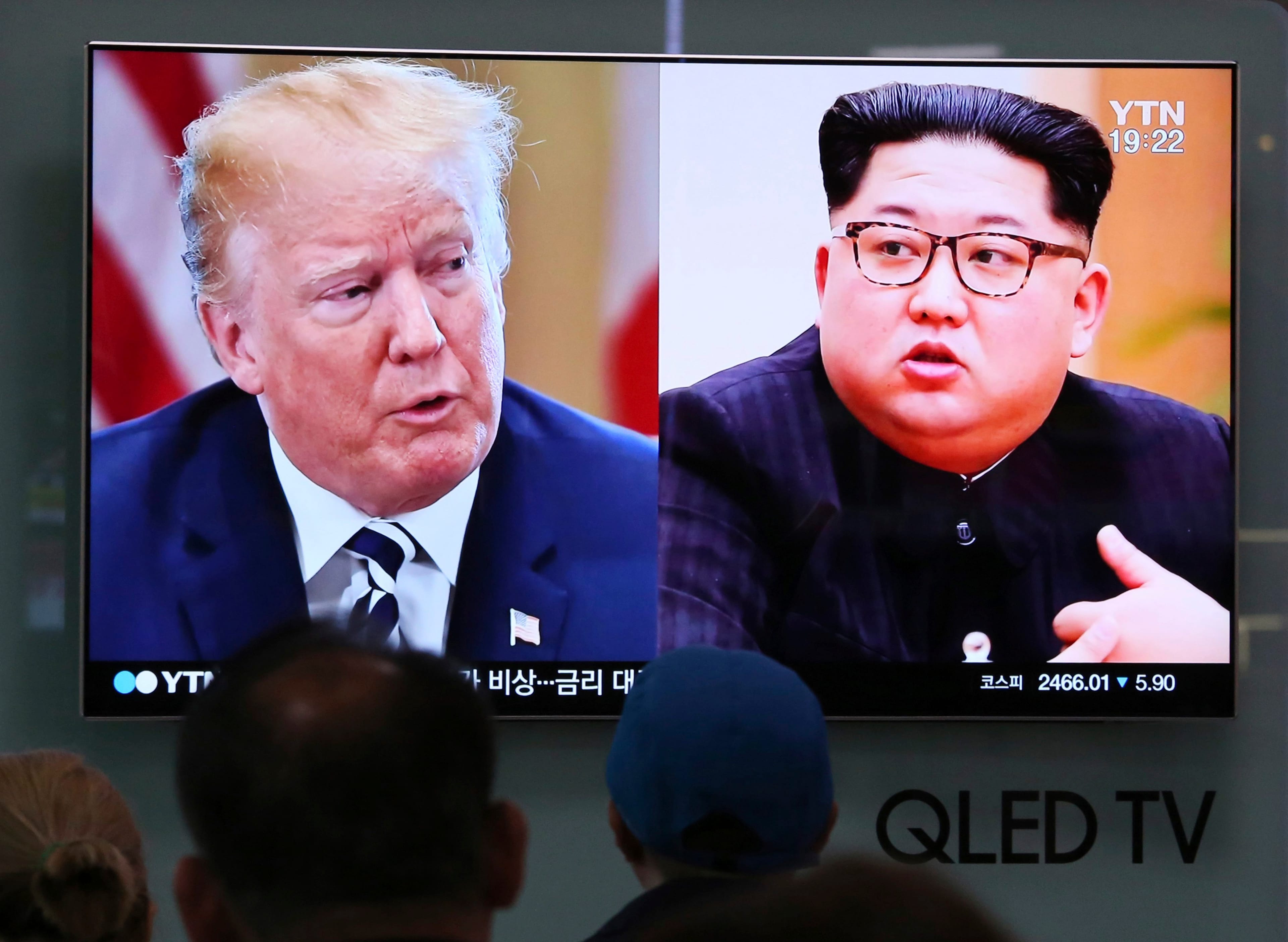 People watch a TV screen showing file footage of U.S. President Donald Trump, left, and North Korean leader Kim Jong Un during a news program at the Seoul Railway Station in Seoul, South Korea, on May 24, 2018. (AP Photo/Ahn Young-joon, File)
