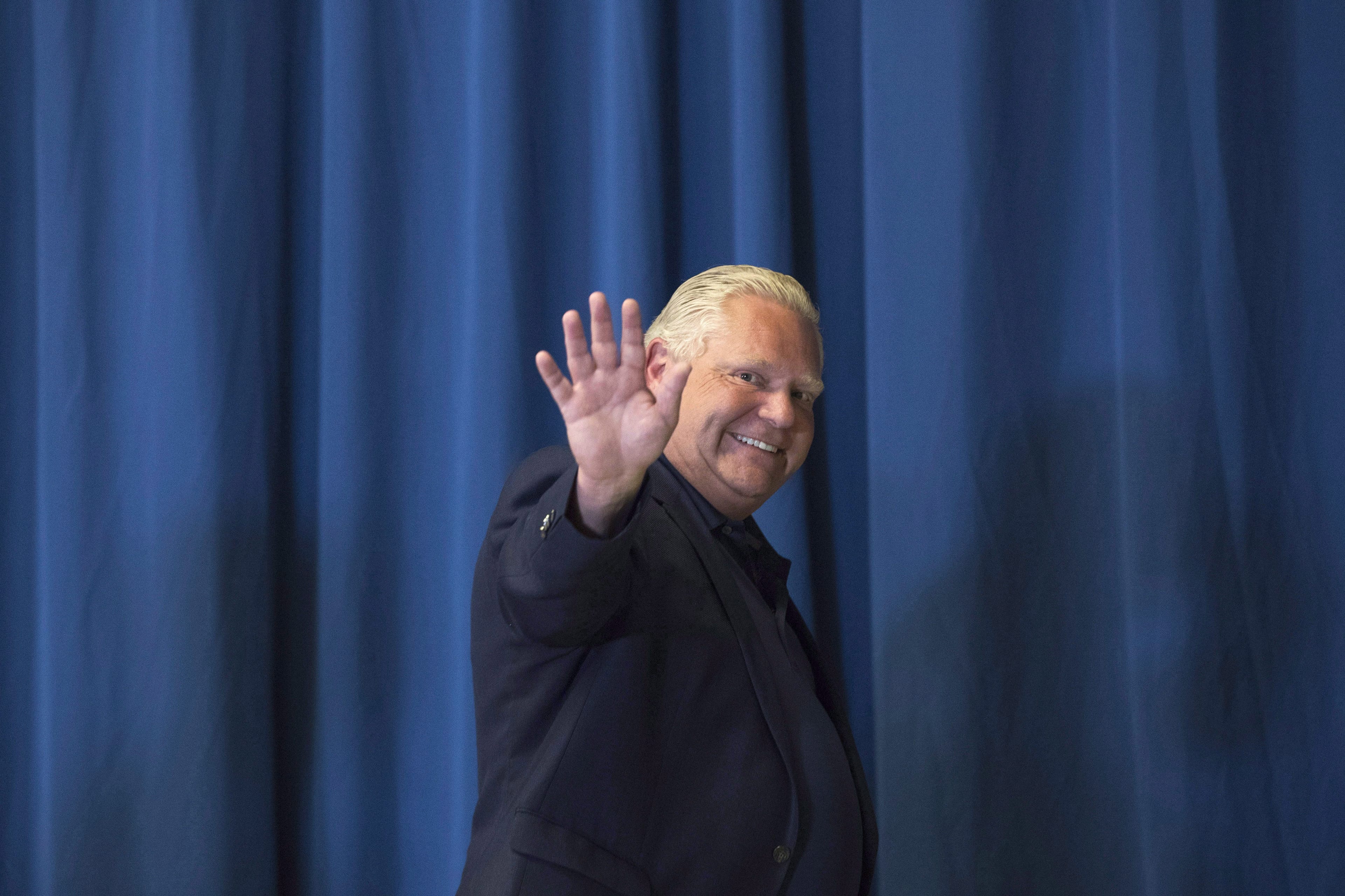 Progressive Conservative party leader Doug Ford waves to the media during a campaign stop in Kingston, Ont., on Sunday on June 3, 2018. (THE CANADIAN PRESS/Lars Hagberg)