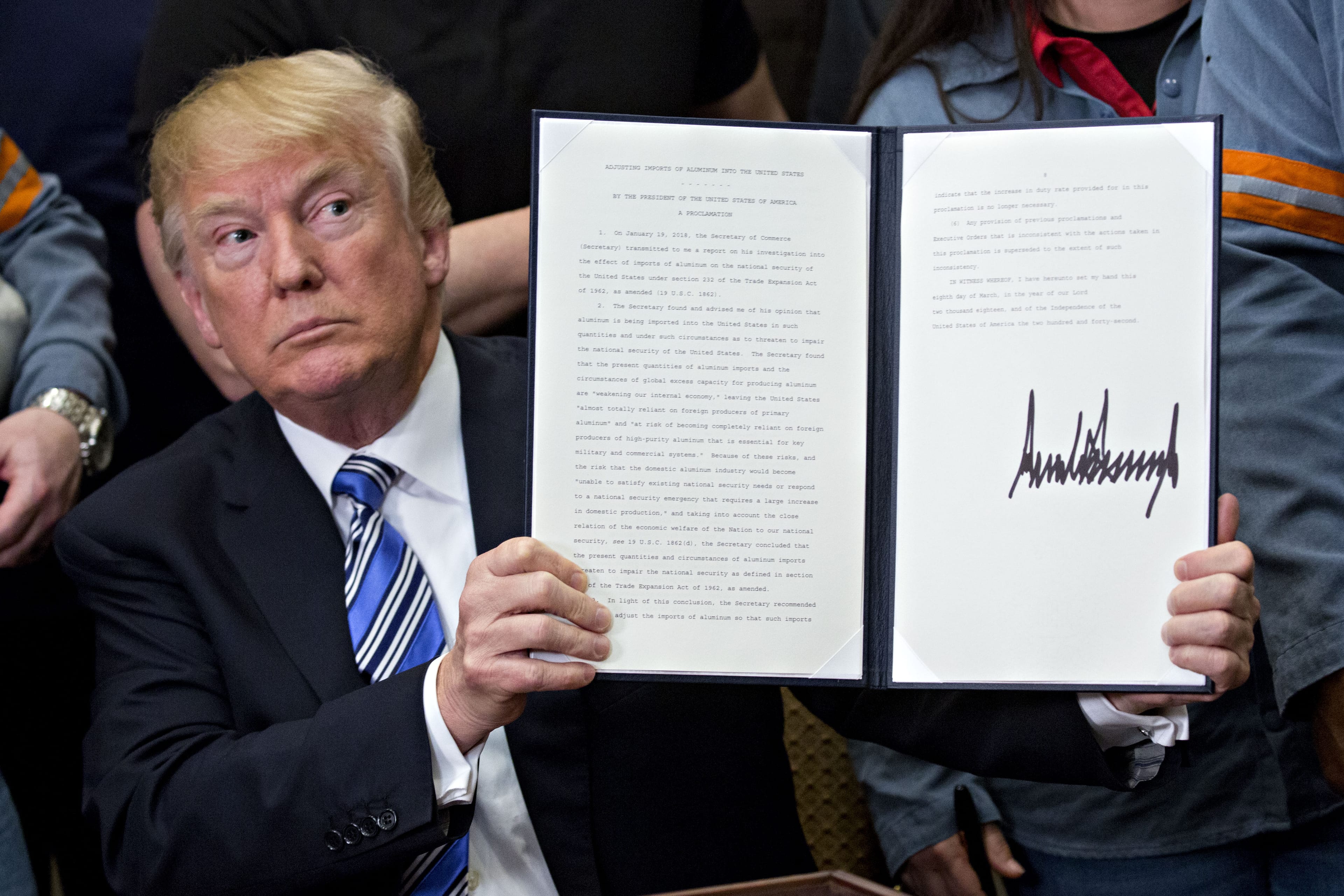 U.S. President Donald Trump holds a signed proclamation on adjusting imports of aluminum into the United States in the Roosevelt Room of the White House in Washington, D.C., U.S., on Thursday, March 8, 2018. (Andrew Harrer/Bloomberg via Getty Images)