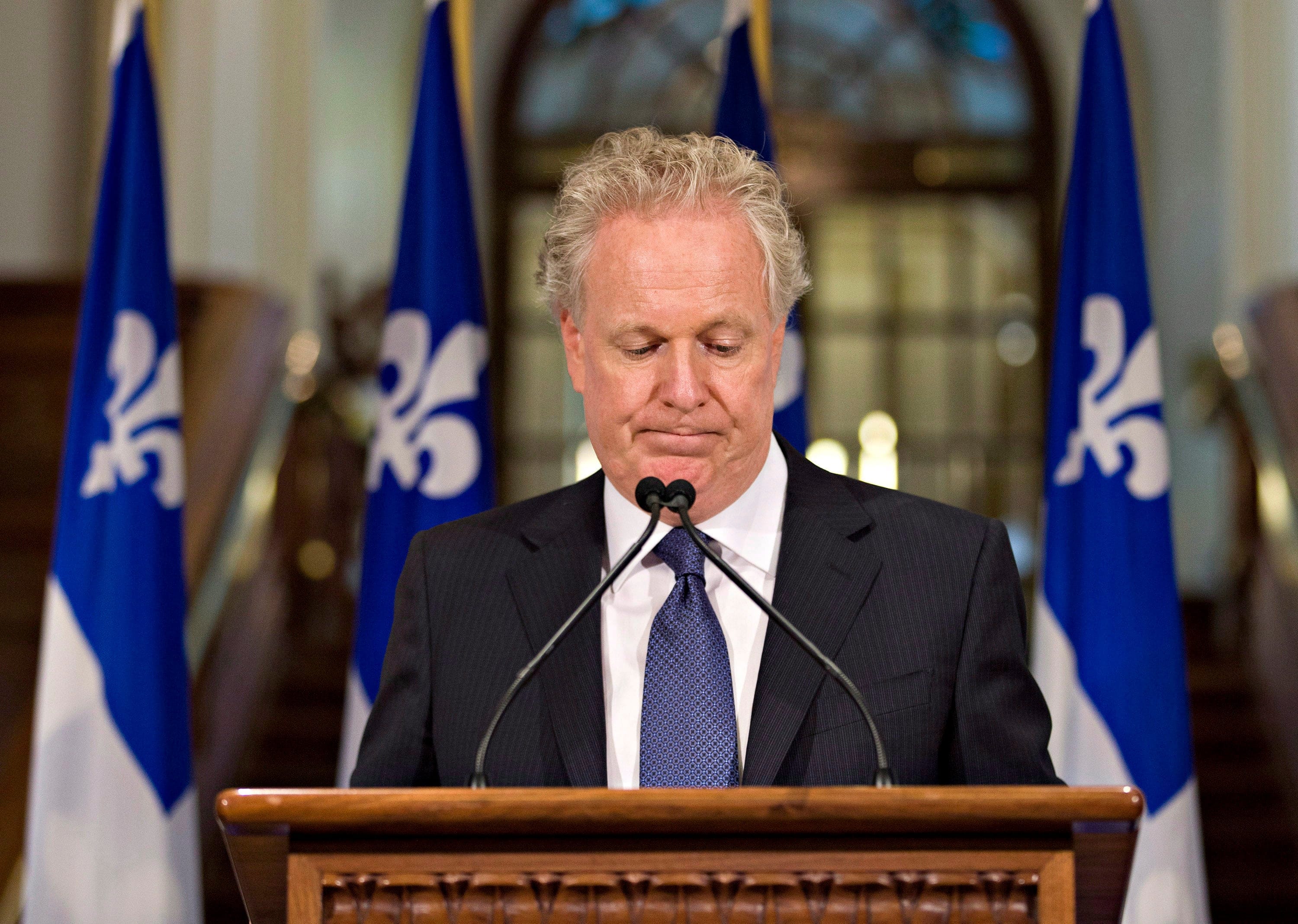 Quebec Liberal Party Leader Jean Charest looks down as he announces his resignation at the Quebec legislature on Wednesday Sept. 5, 2012. (Jacques Boissinot/CP)
