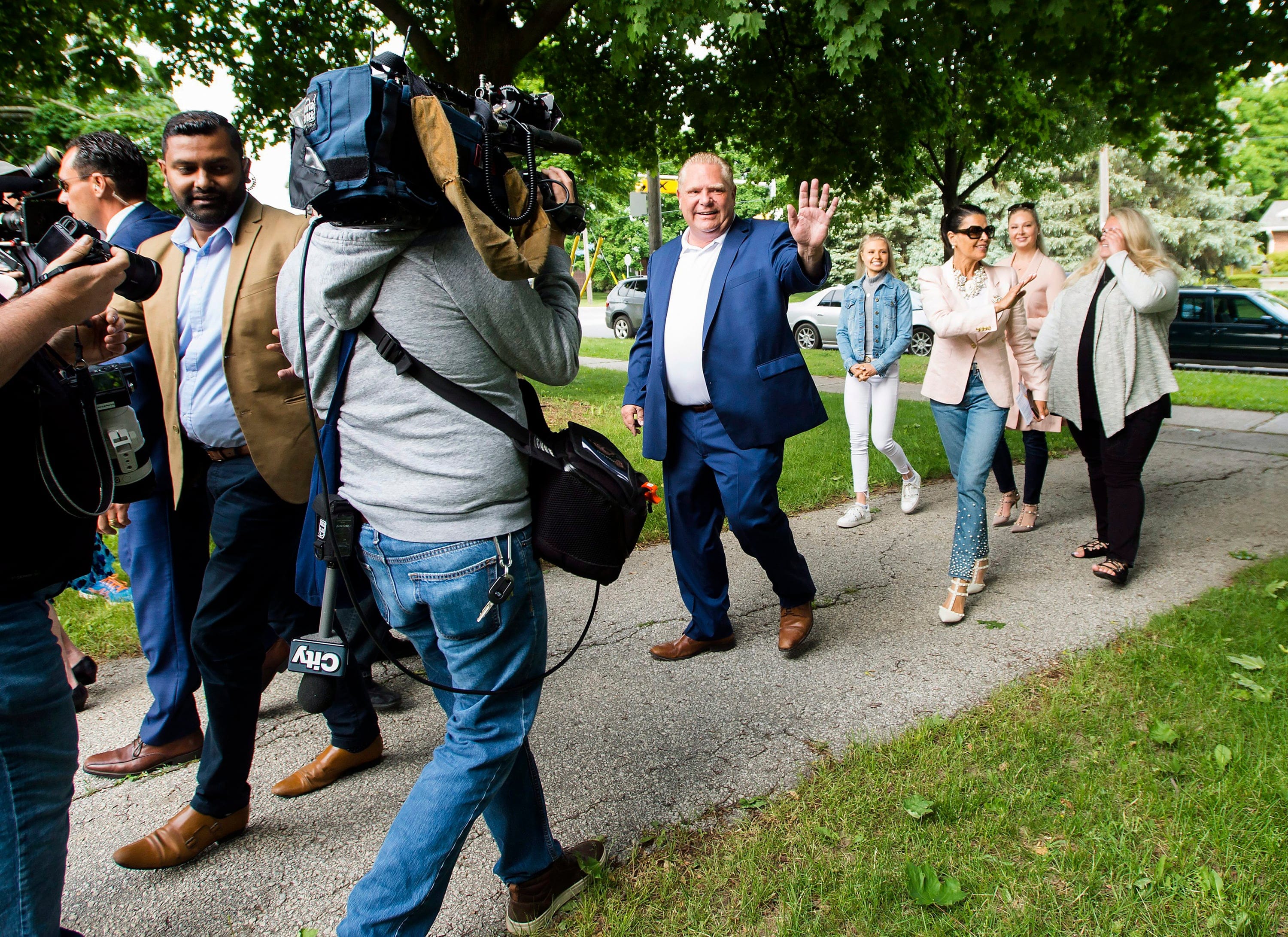 Ontario PC leader Doug Ford, centre, walks with his family to cast their votes in Toronto, on Thursday, June 7, 2018. (Nathan Denette/CP)