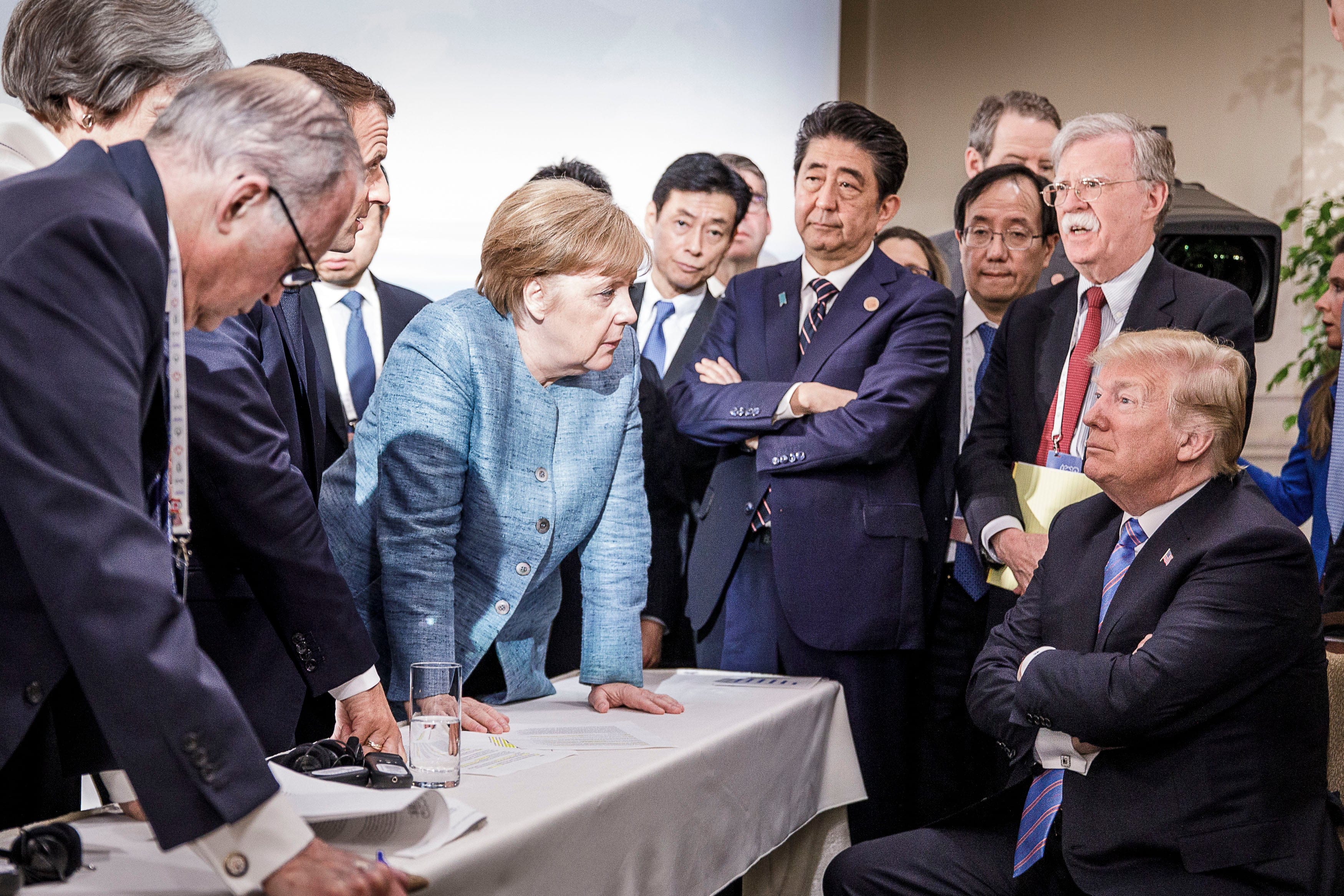 German Chancellor Angela Merkel deliberates with US president Donald Trump on the sidelines of the official agenda on the second day of the G7 summit on June 9, 2018 in Charlevoix, Canada. (Photo by Jesco Denzel /Bundesregierung via Getty Images)