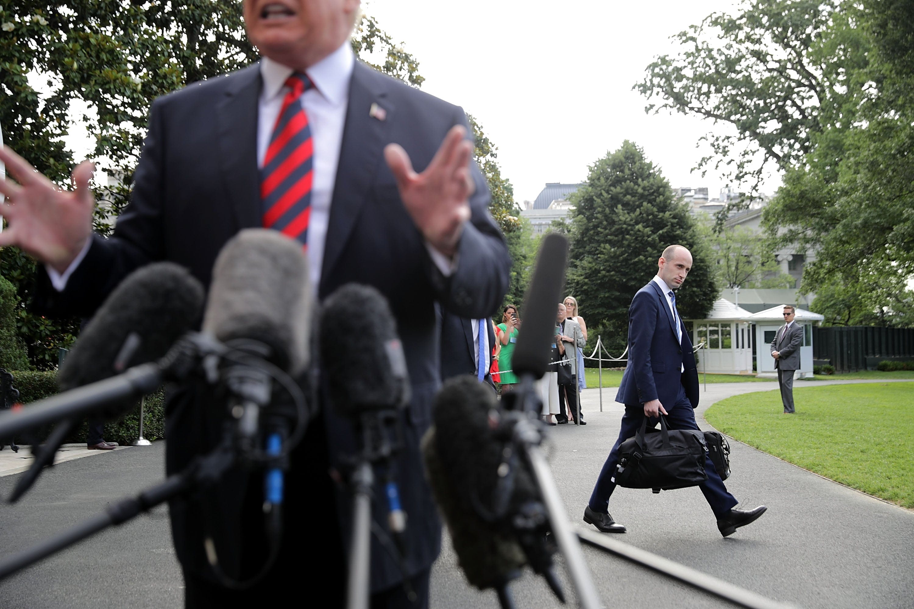 Stephen Miller, a senior advisor to the President (right), walks behind U.S. President Donald Trump as he talks to reporters before they depart the White House June 8, 2018 in Washington, D.C. (Chip Somodevilla/Getty Images)