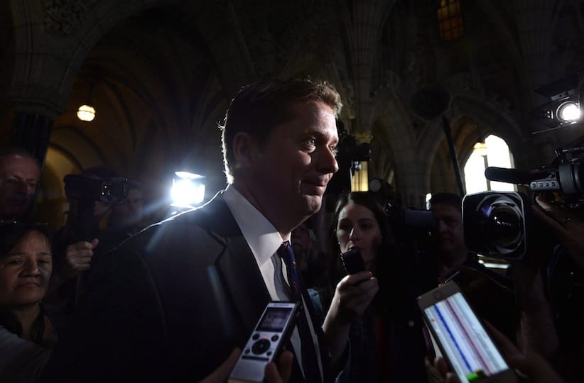 Scheer makes his way past reporters as he leaves a caucus meeting on Parliament Hill in Ottawa on Wednesday, June 13, 2018. (THE CANADIAN PRESS/Justin Tang)