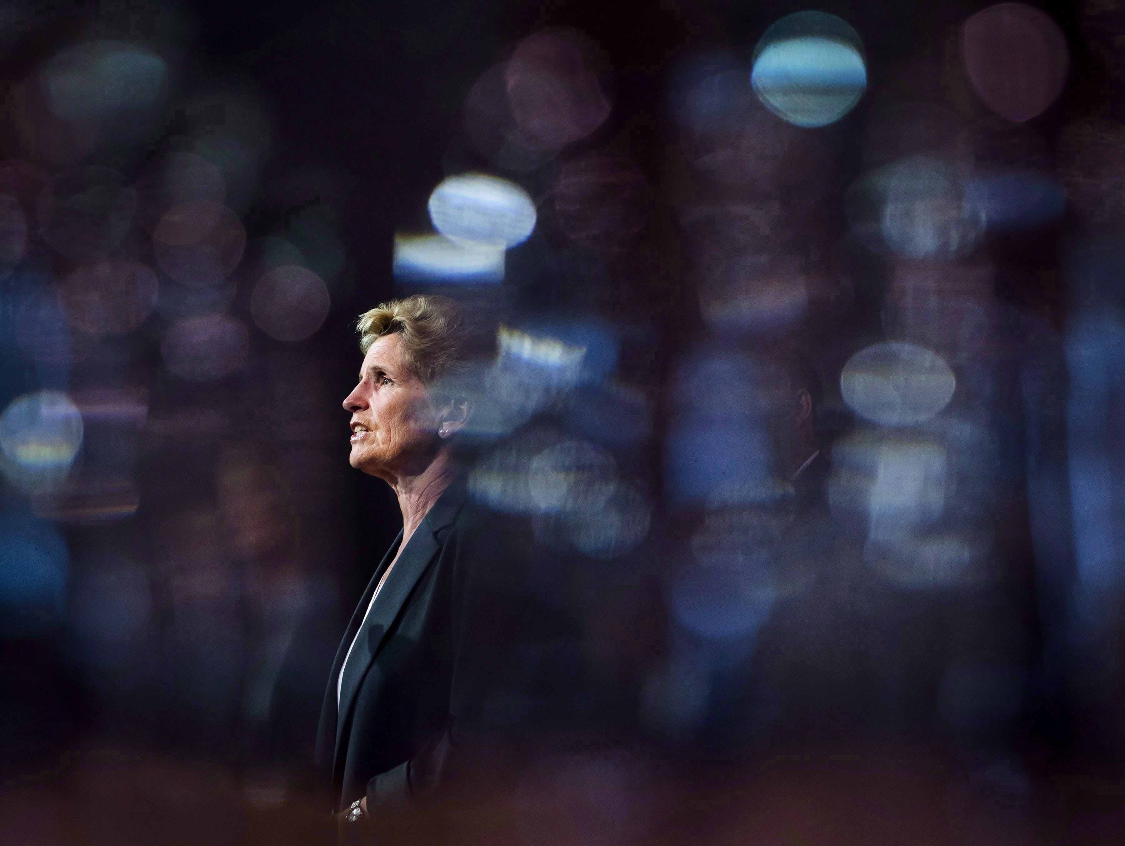 Ontario Liberal Leader Kathleen Wynne is pictured between glasses as she speaks during a campaign stop at Crosscut Distillery in Sudbury, Ont., on Wednesday, May 23, 2018. (Nathan Denette/CP)