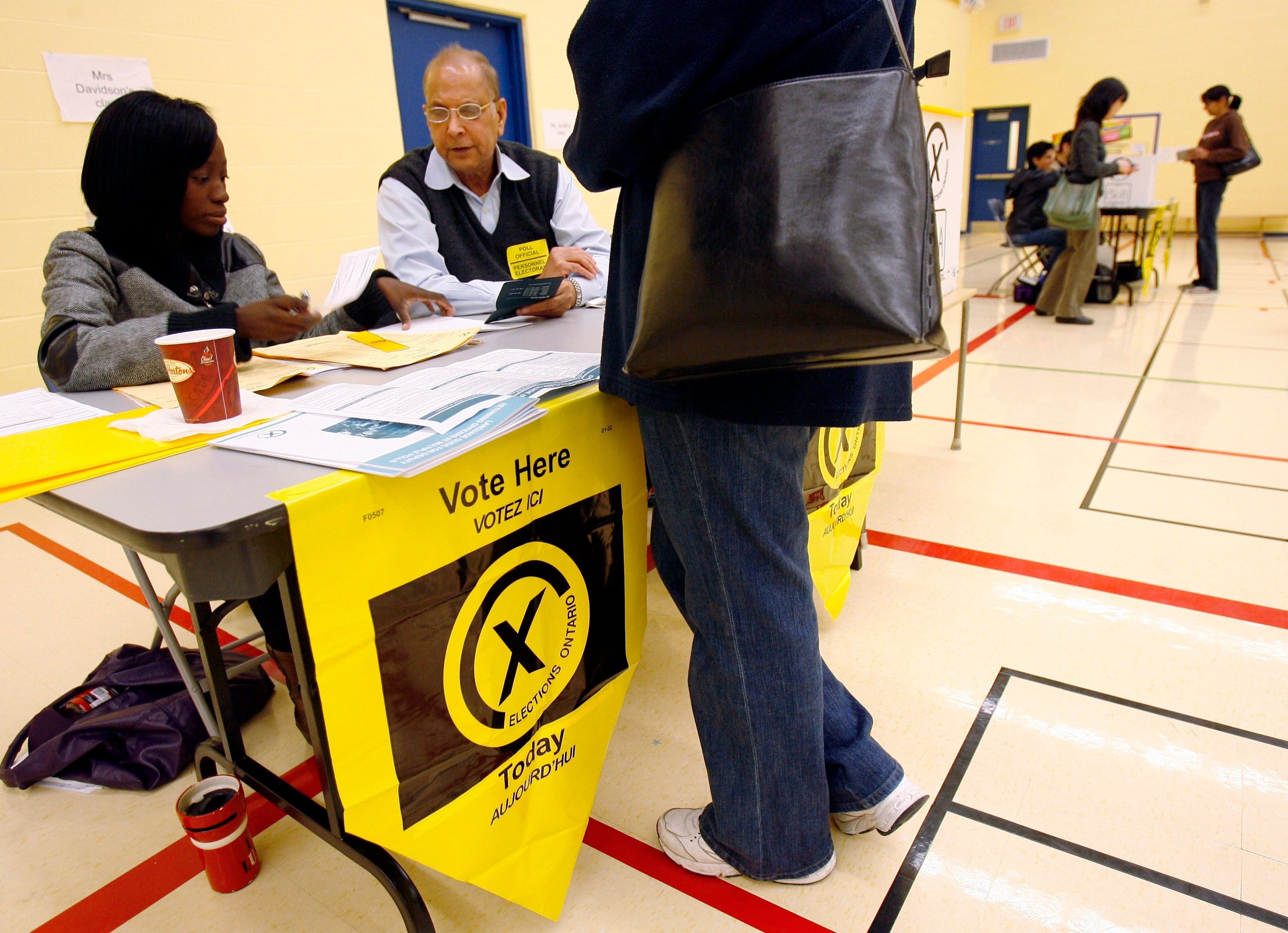 Elections officials man a polling station during the Ontario provincial election at a Mississauga voting station, Wednesday, Oct. 10, 2007. THE CANADIAN PRESS/J.P. Moczulski