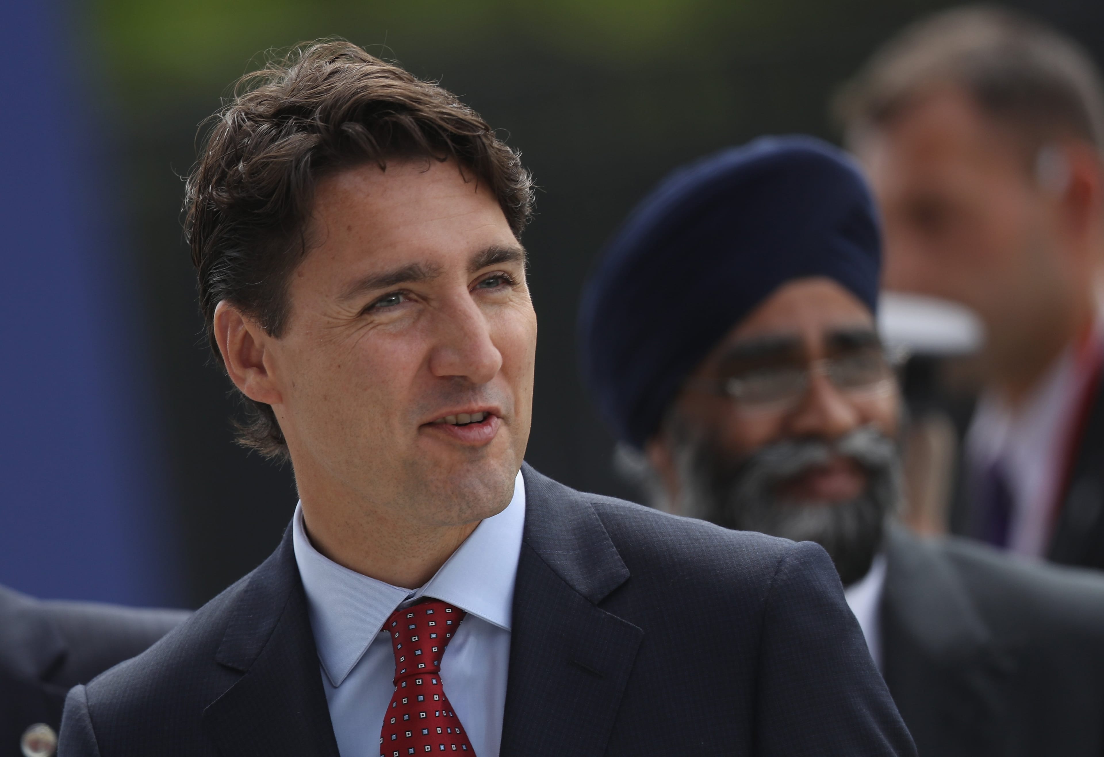 Justin Trudeau and Canadian Defense Minister Harjit Sajjan arrive for the Warsaw NATO Summit on July 8, 2016 in Warsaw, Poland. (Sean Gallup/Getty Images)