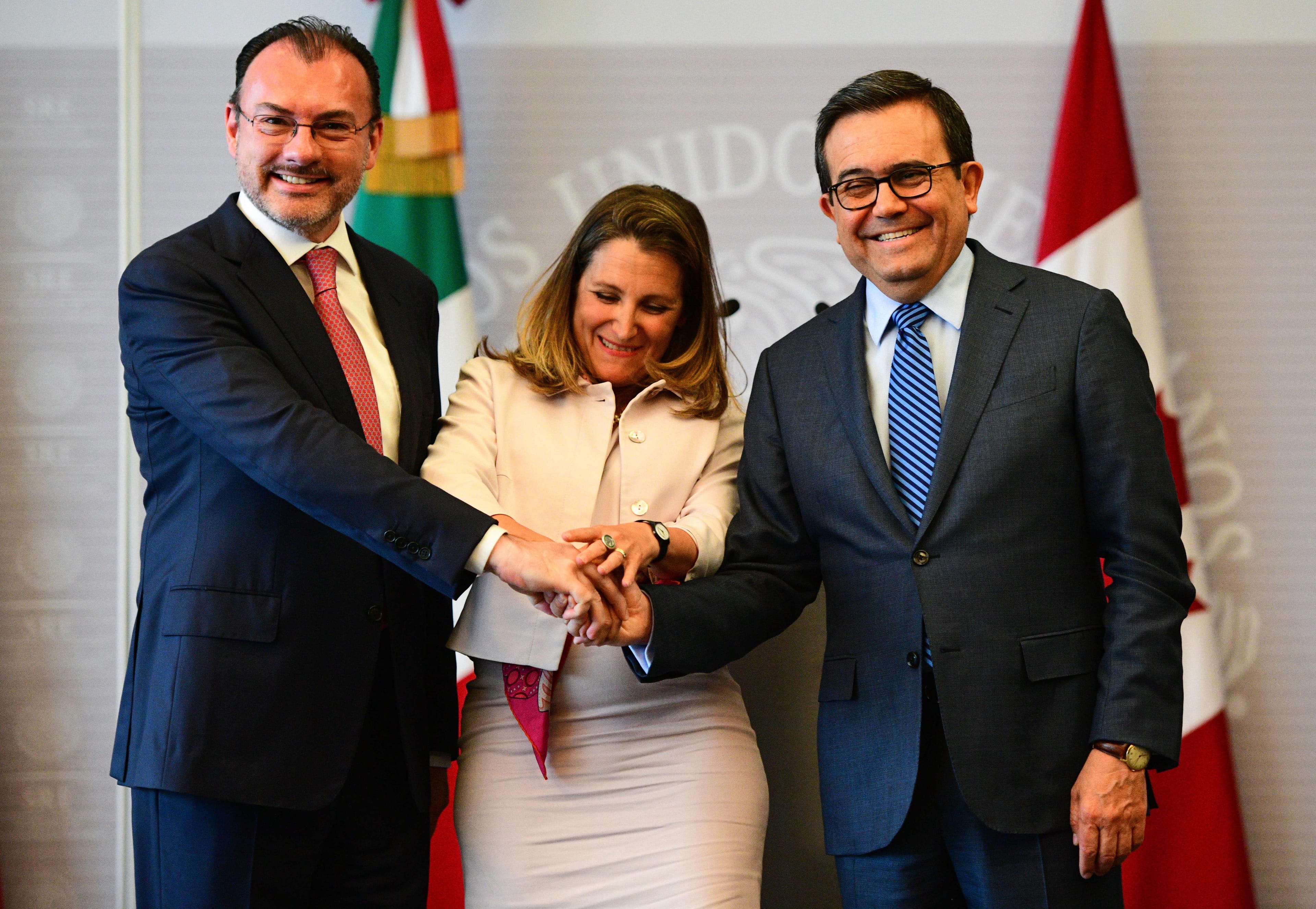 Mexican Foreign Minister Luis Videgaray, Canadian Minister of Foreign Affairs Chrystia Freeland and Mexican Economy Minister Idelfonso Guajardo joke as they pose for pictures after a press conference at the Foreign Office in Mexico City, on July 25, 2018. (Ronaldo Schemidt/AFP/Getty Images)