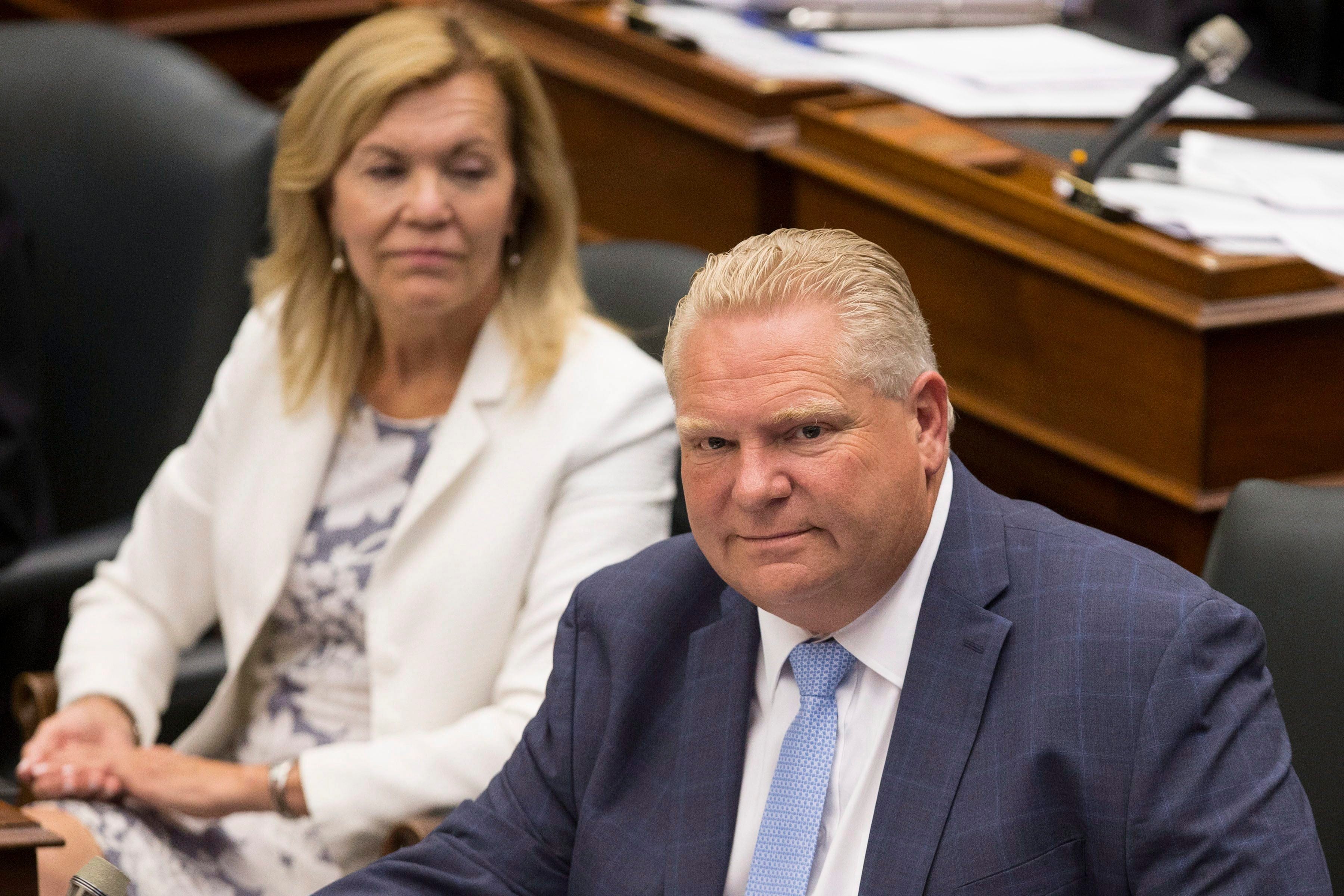 Ontario Premier Doug Ford, right, sits next to PC MPP Christine Elliott during Question Period at Queen's Park, in Toronto on Tuesday, July 31, 2018. THE CANADIAN PRESS/Chris Young