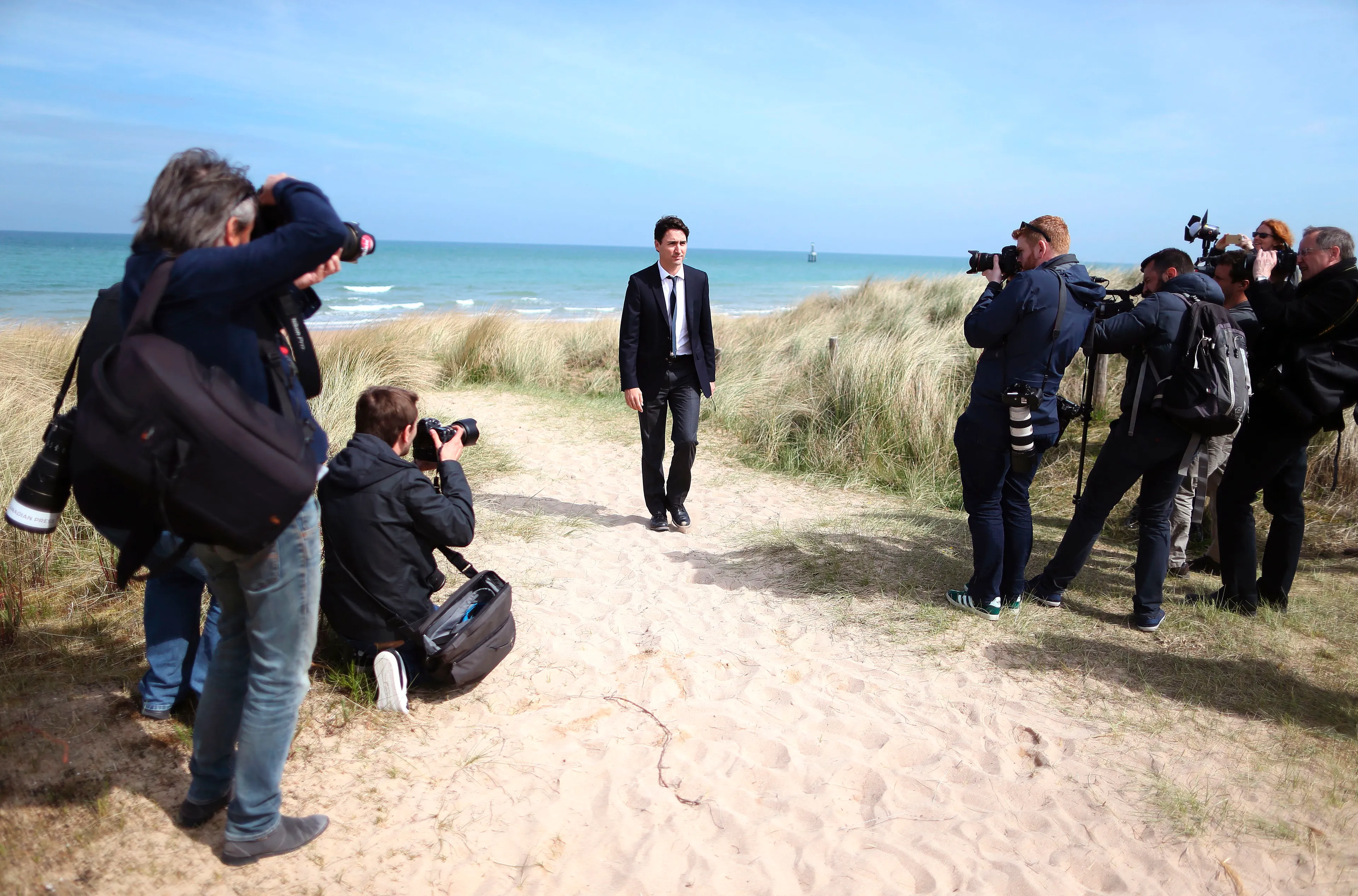 Press photographers gather as Canadian Prime Minister Justin Trudeau leaves Juno beach with his family (unseen) on April 10, 2017 in Courseulles-sur-Mer, northwestern France. Juno Beach was one of five beaches of the Allied invasion of German-occupied France in the Normandy landings on June 6, 1944 during the Second World War. (Charly Triballeau/AFP/Getty Images)