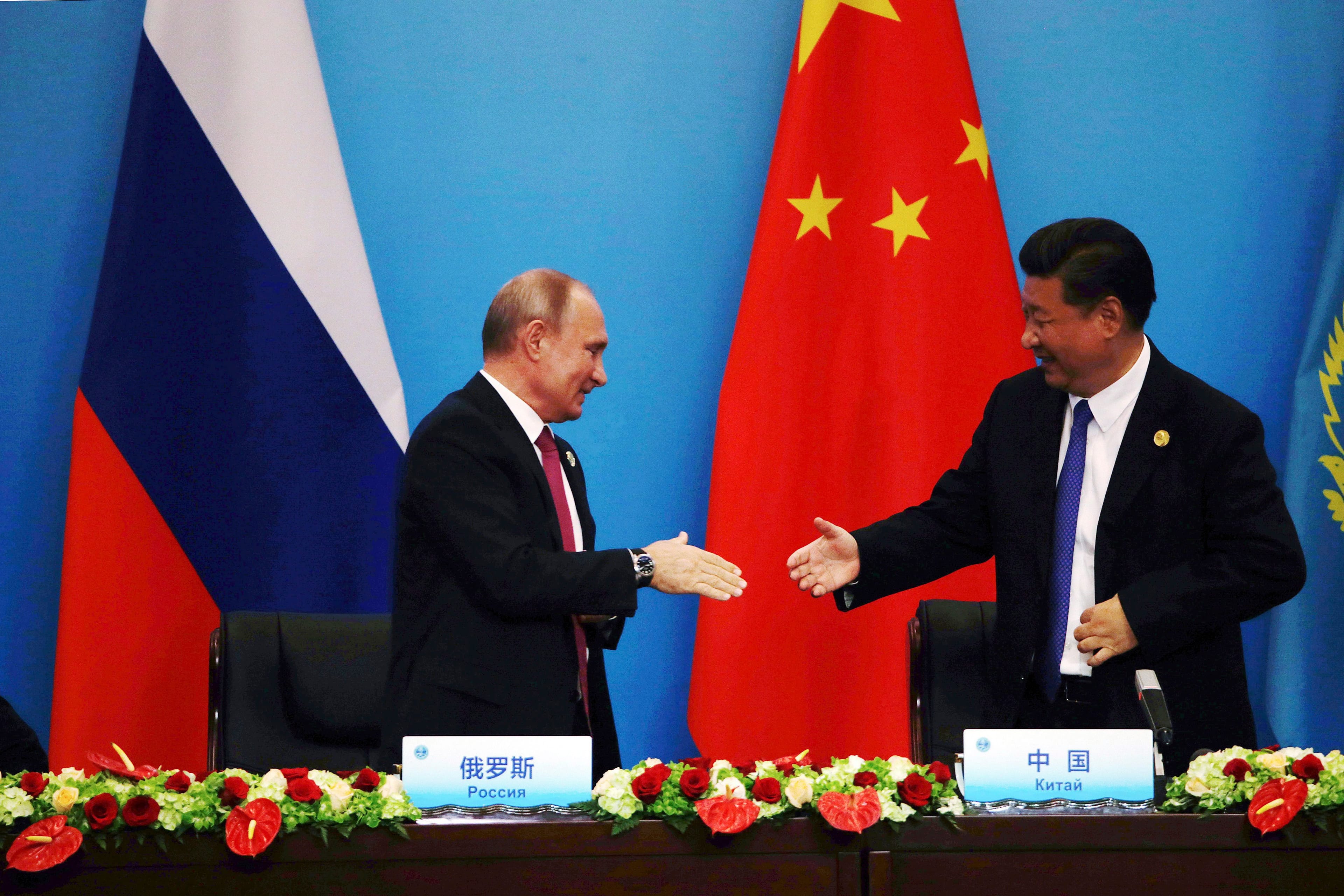 Chinese President Xi Jinping, right, shakes hands with Russian President Vladimir Putin after a joint press conference for the Shanghai Cooperation Organization (SCO) Summit in Qingdao in eastern China's Shandong Province, Sunday, June 10, 2018. Xi extolled free trade and criticized "selfish, short-sighted" policies during the closely orchestrated gathering, standing in stark contrast with the G-7 summit that ended in disarray over trade tensions. (AP Photo/Dake Kang)
