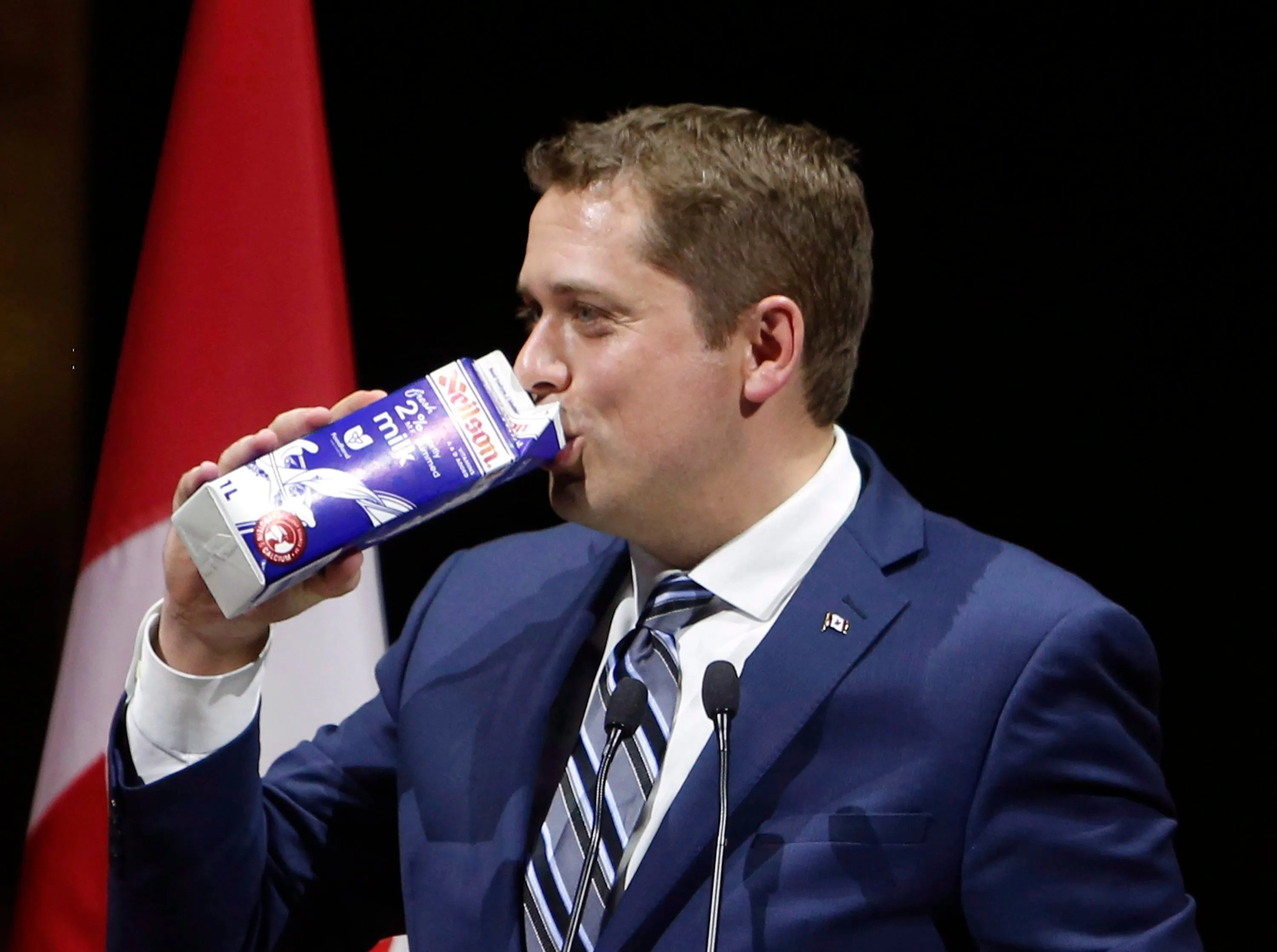 Conservative Leader Andrew Scheer drinks milk as he takes the stage at the National Press Gallery Dinner in Gatineau, Quebec, Saturday June 3, 2017.THE CANADIAN PRESS/Fred Chartrand