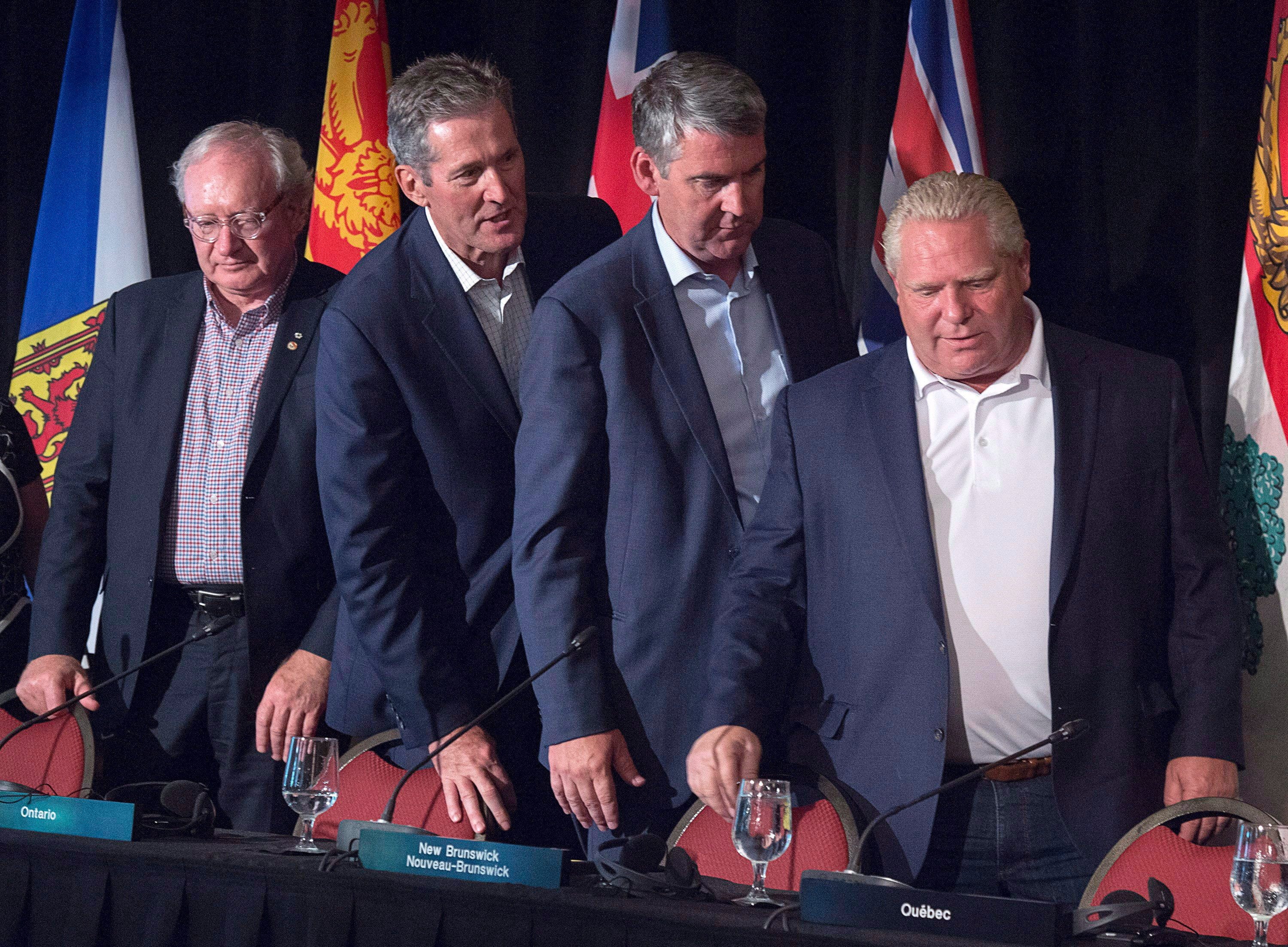 Prince Edward Island Premier Wade MacLauchlan, Manitoba Premier Brian Pallister, Nova Scotia Premier Stephen McNeil and Ontario Premier Doug Ford, head from the closing news conference of the Canadian premiers meeting in St. Andrews, N.B. on Friday, July 20, 2018. (THE CANADIAN PRESS/Andrew Vaughan)