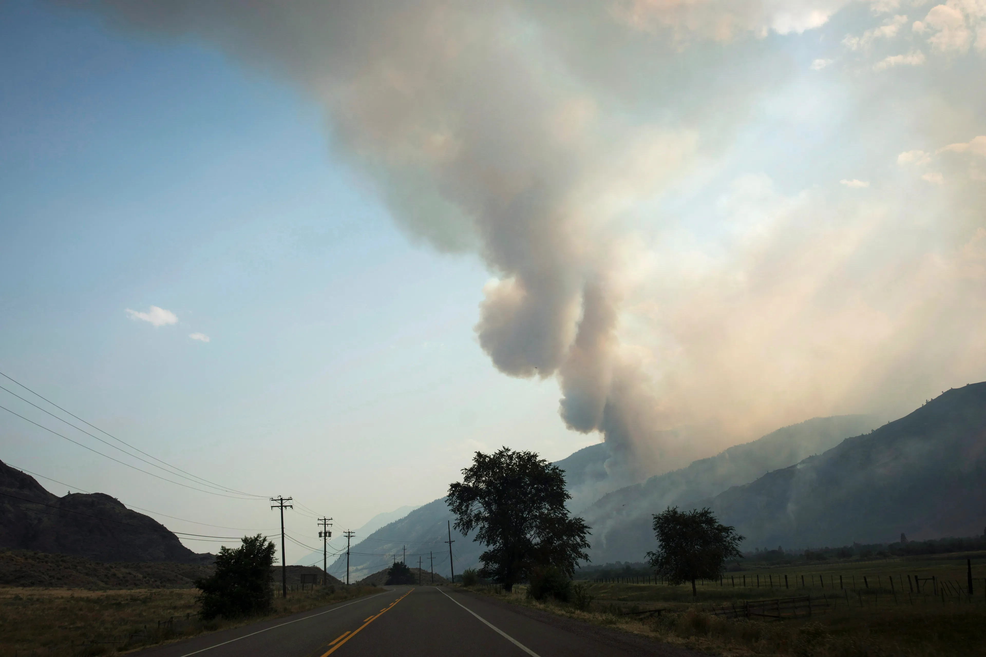 The Snowy Mountain wildfire, currently the largest in B.C., is visible from Cawston, B.C., Thursday, Aug. 2, 2018. THE CANADIAN PRESS/Melissa Renwick