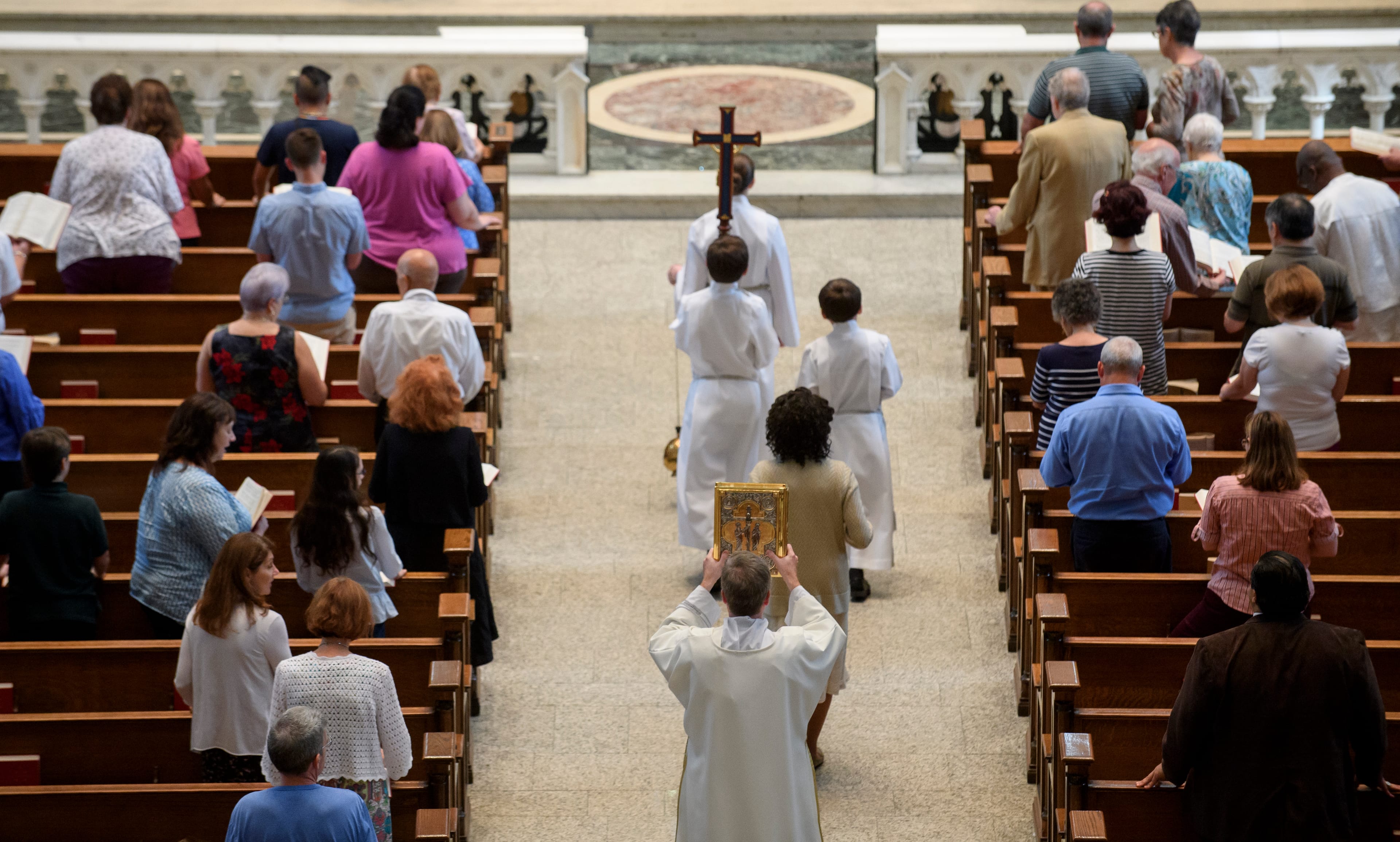 Parishioners worship during a mass to celebrate the Assumption of the Blessed Virgin Mary at St Paul Cathedral, the mother church of the Pittsburgh Diocese on Aug. 15, 2018 in Pittsburgh, Pennsylvania. (Photo by Jeff Swensen/Getty Images)