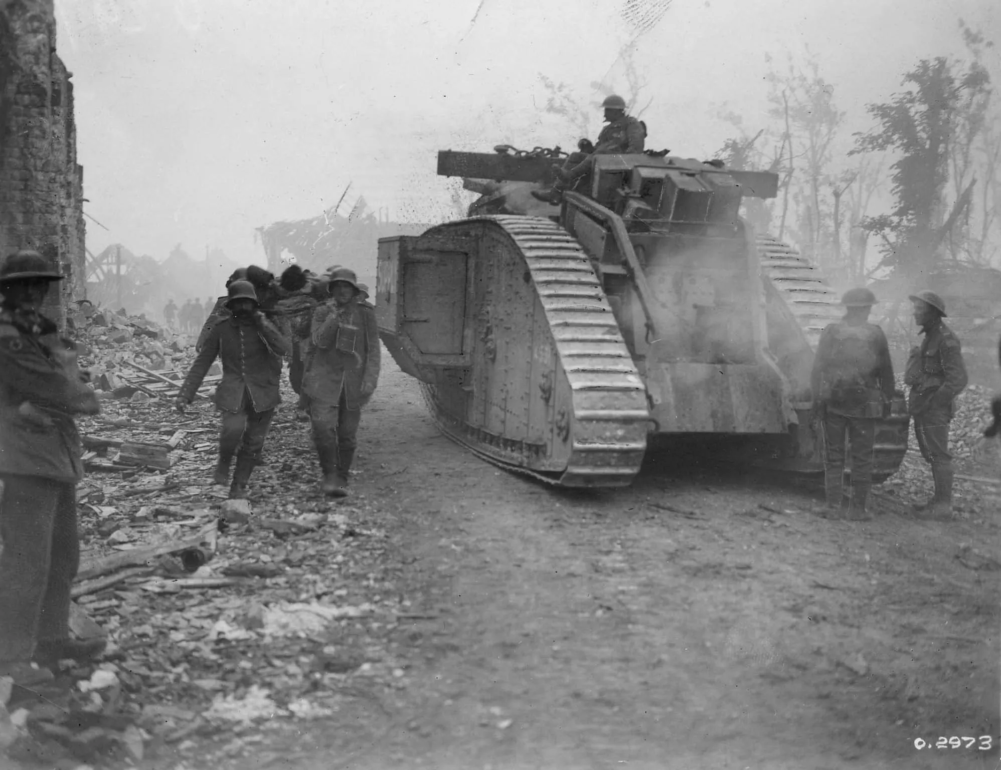 World War I - Artillery. Verso of photograph reads: Tanks advancing up the Amiens-Roye Rd. August 1918. Caption: Amid the heat and dust of Amiens - Tanks advancing up the Amiens-Roye Rd. on August 8, 1918, when the Canadians advanced six miles. So fast was this great surprise attack, planned by Foch himself, that the tanks had a hard time keeping up. But the effect of one of these monsters coming slowlyand purposefully across the fields was enough to make the bravest man quake. They spat machine-gun fire, trod down barb wire and pushed over walls, never pausing in their strange turtle-like advance. (Royal Canadian Air Force)