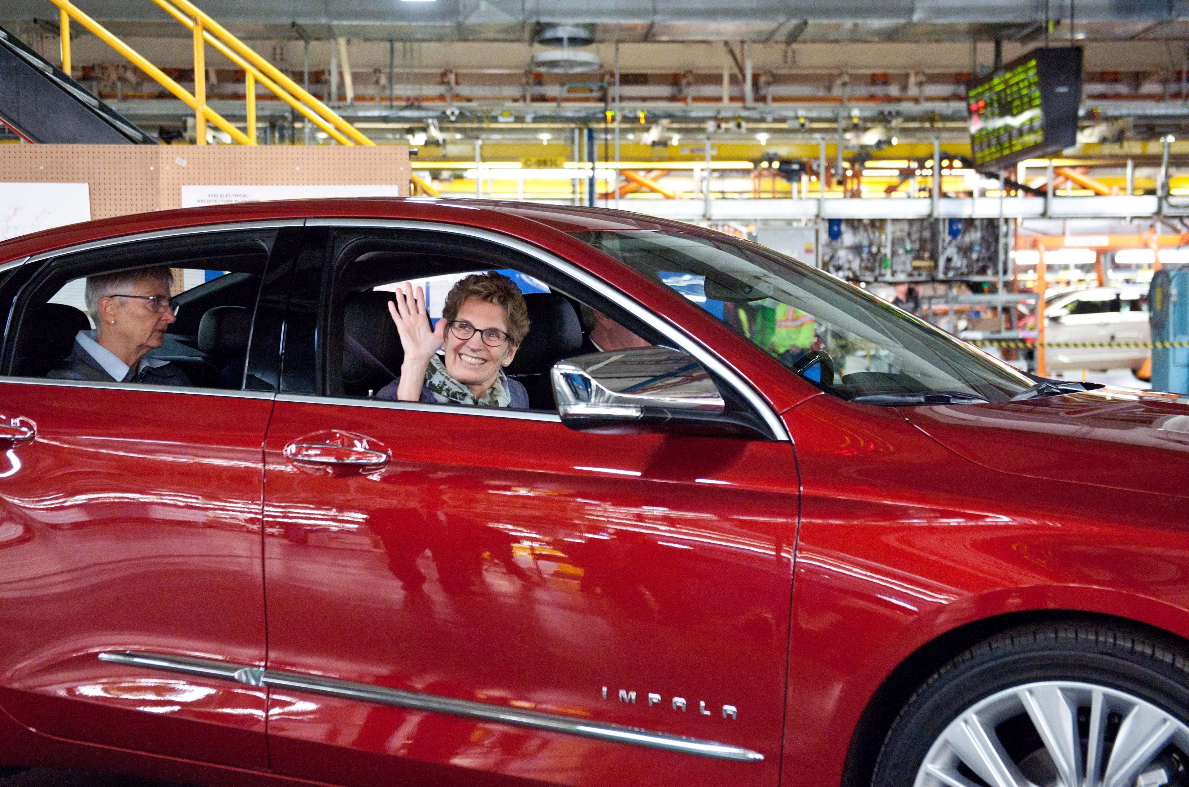 Former Ontario premier Kathleen Wynne in a Chevrolet Impala during a tour of the General Motors Oshawa Assembly Plant in 2014. THE CANADIAN PRESS/Galit Rodan