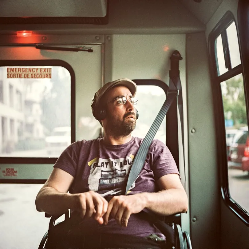 Jo rides the bus home from his day program at McCormick Home. He listens to music on the ride home, usually Pearl Jam, which never fails to put him in a good mood. (Photograph by Chris Donovan)