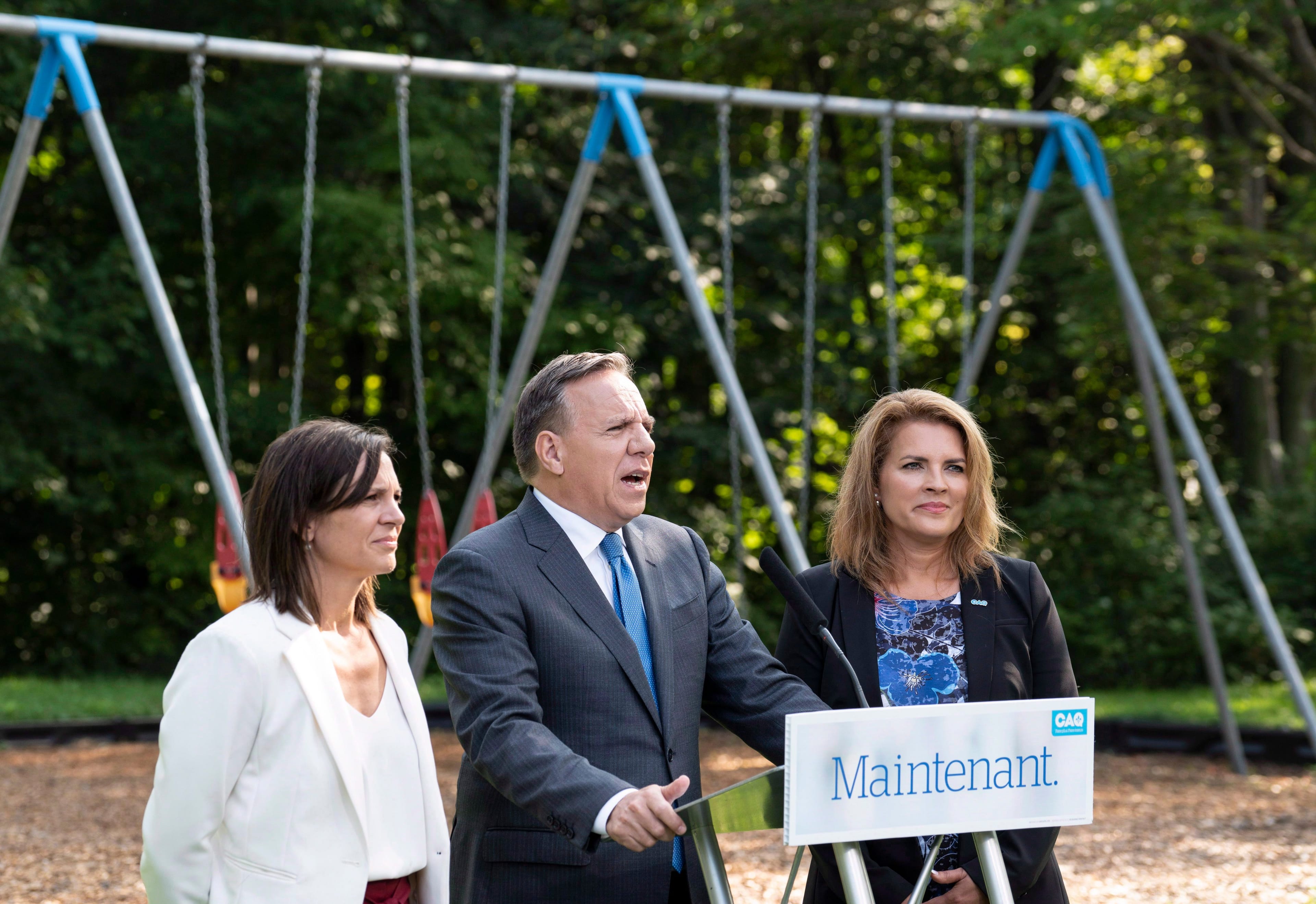 Coalition Avenir Québec Leader François Legault, flanked by local candidates Isabelle Charest, left, and Genevieve Hebert in Bromont, Que., on Aug. 27, 2018. (Paul Chiasson/CP)
