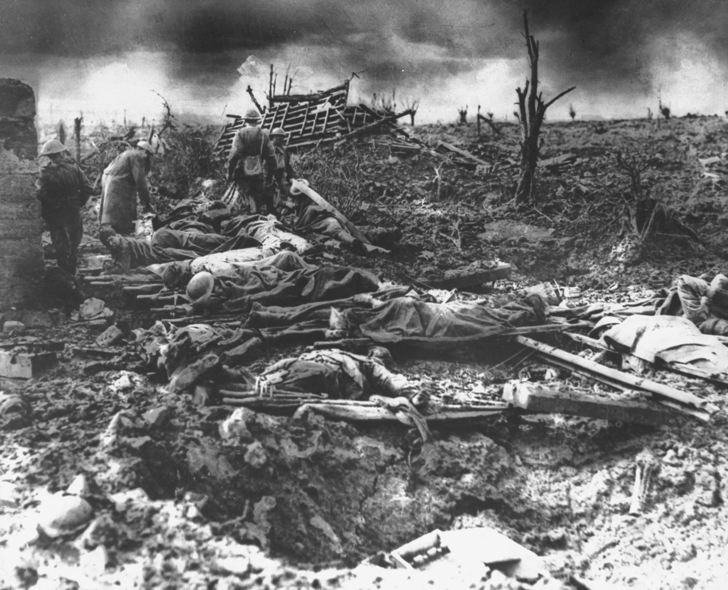Dawn rising on muddy, horrific battlefield of Passchendaele as soldiers tend to the dead during WWI. (Mansell/The LIFE Picture Collection/Getty Images)