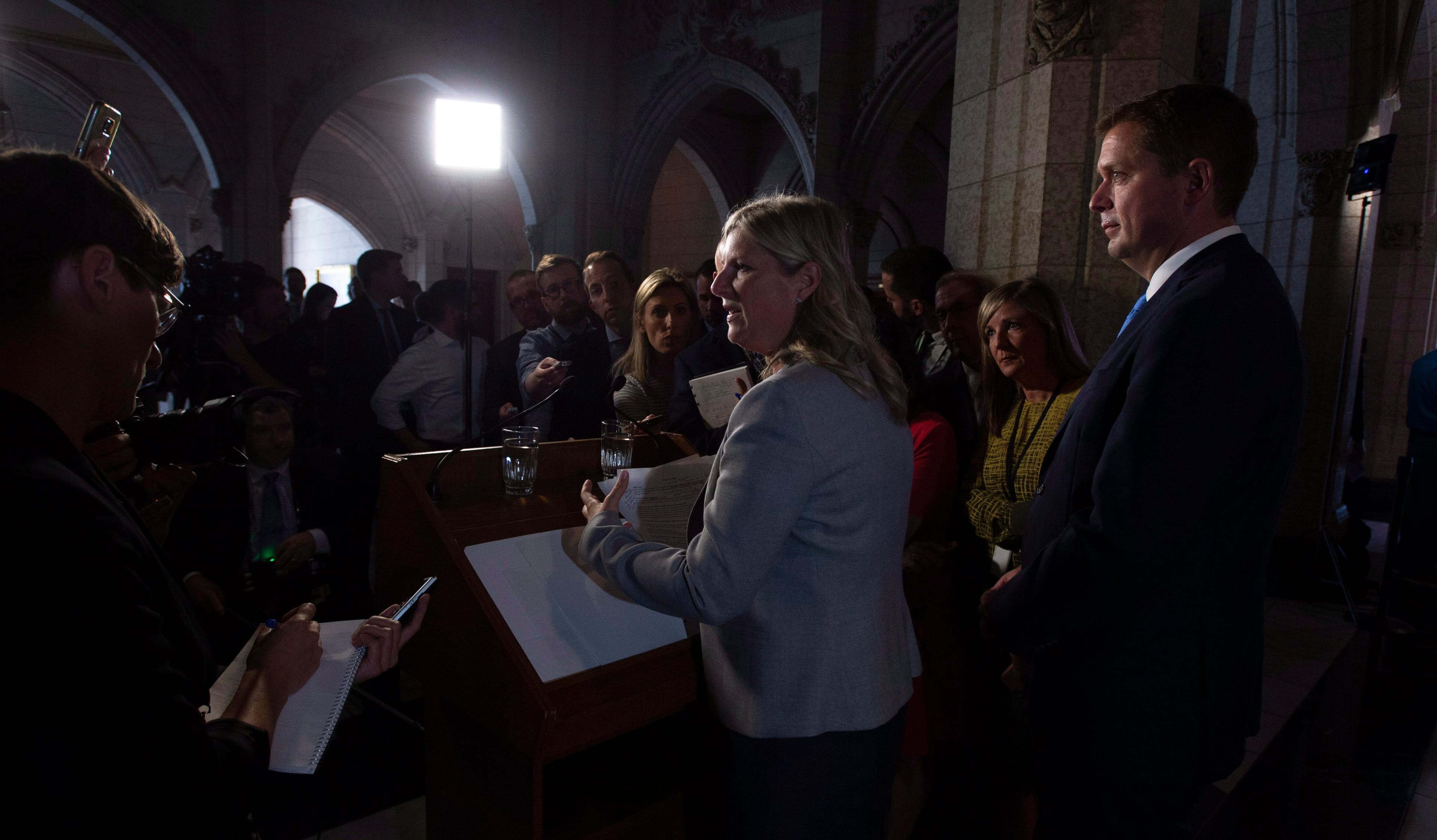 Leader of the Opposition Andrew Scheer (right) looks on as Leona Alleslev, who crossed the floor from the Liberal party to Conservative party speaks with the media about her decision on Parliament Hill in Ottawa, Monday September 17, 2018. THE CANADIAN PRESS/Adrian Wyld