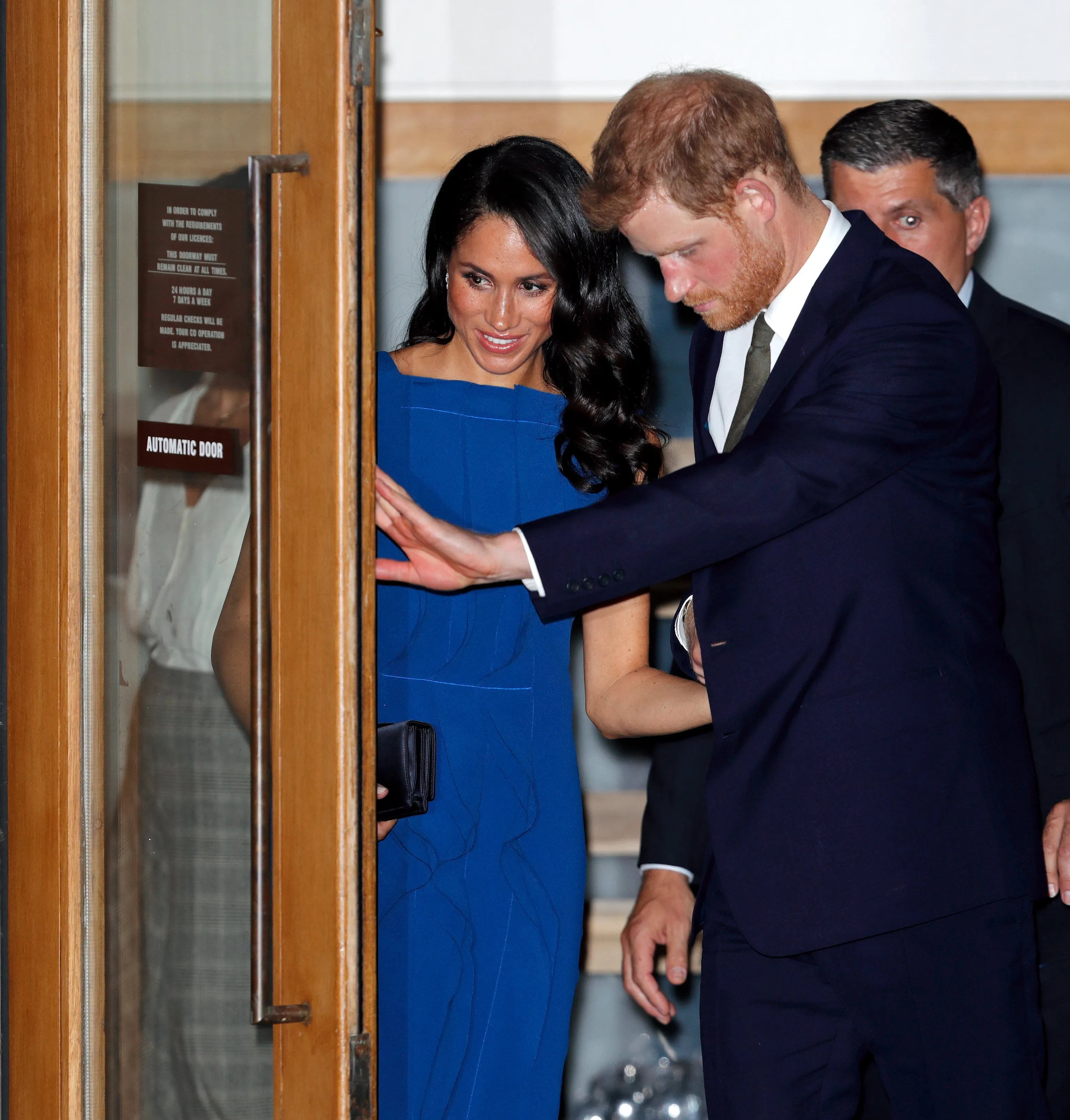 Prince Harry, Duke of Sussex, holds open the door for Meghan, Duchess of Sussex as they depart the "100 Days of Peace" concert to commemorate the centenary of the end of the First World War at Central Hall Westminster on September 6, 2018 in London, England. (Max Mumby/Indigo/Getty Images)