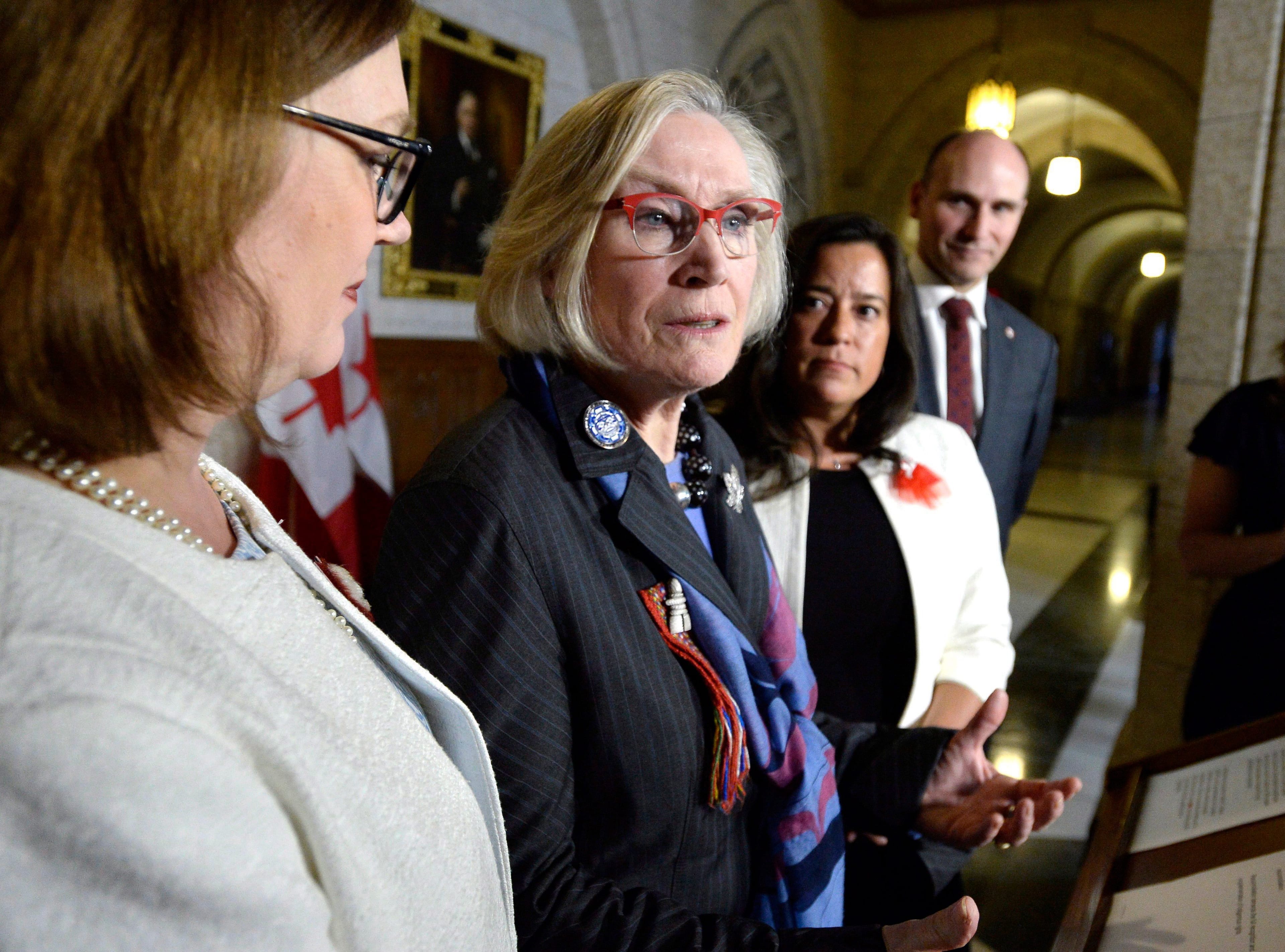 Minister of Crown-Indigenous Relations Carolyn Bennett, speaks about the framework for the recognition and implementation of Indigenous rights, as Minister of Indigenous Services Jane Philpott (left), Minister of Justice Jody Wilson-Raybould, and Minister of Families, Children and Social Development Jean-Yves Duclos look on, in the House of Commons on Feb. 14, 2018. (THE CANADIAN PRESS/Justin Tang)