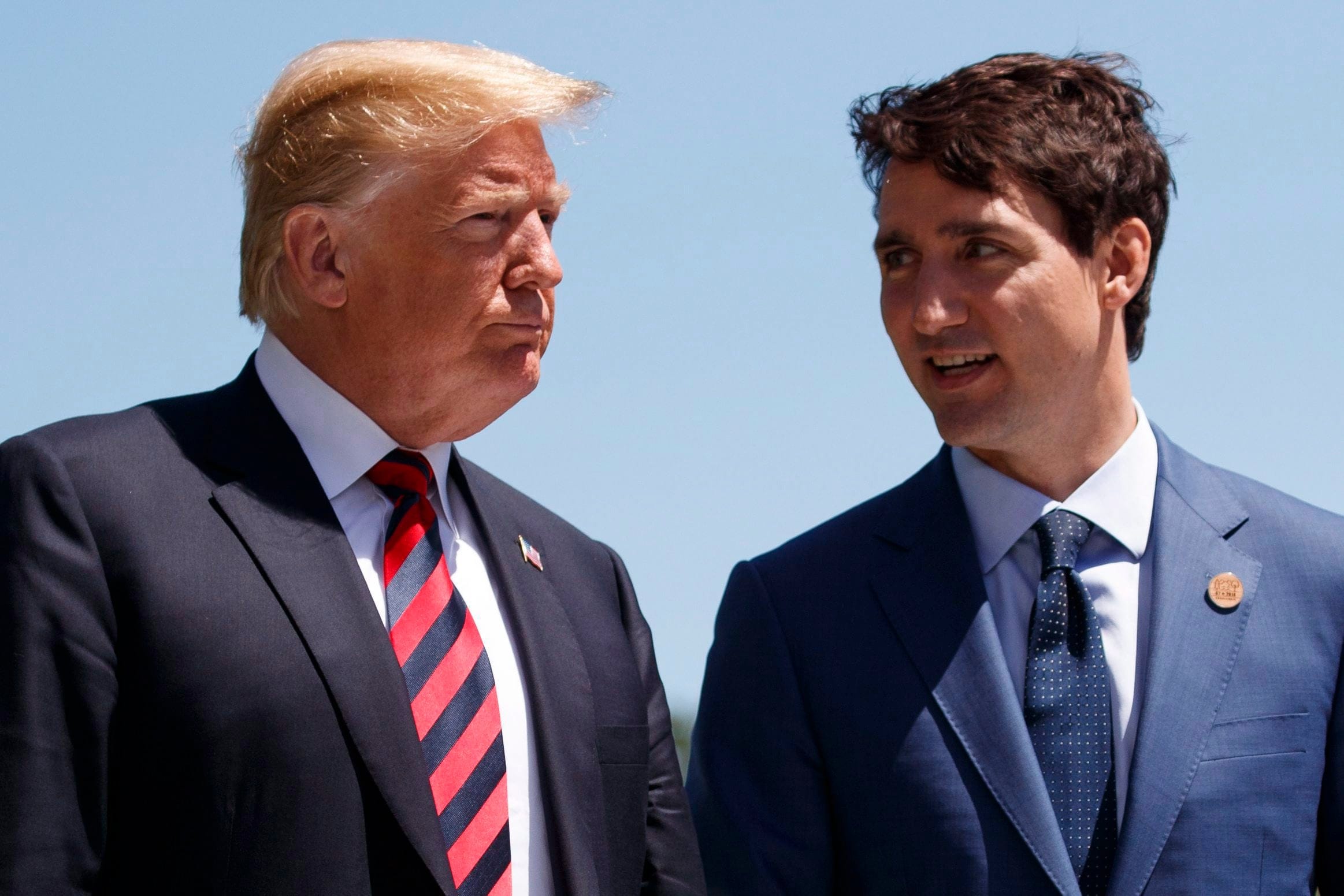 U.S. President Donald Trump talks with Prime Minister Justin Trudeau during a G-7 Summit welcome ceremony in Charlevoix, Que., on June 29, 2018 (AP Photo/Evan Vucci, File)