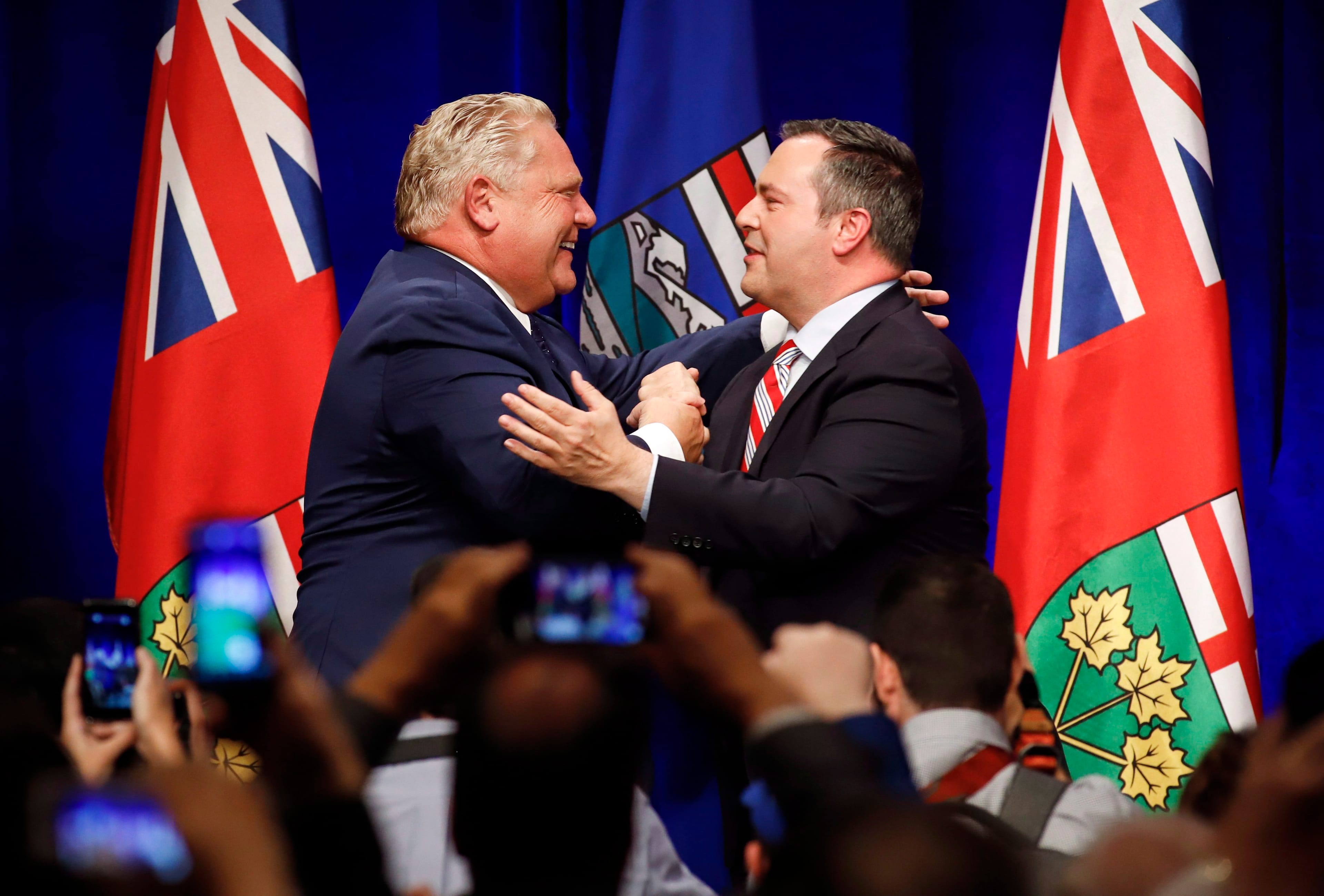 Ontario Premier Doug Ford (left) and United Conservative Leader Jason Kenney embrace on stage at an anti-carbon tax rally in Calgary, Friday, Oct. 5, 2018. (THE CANADIAN PRESS/Jeff McIntosh)