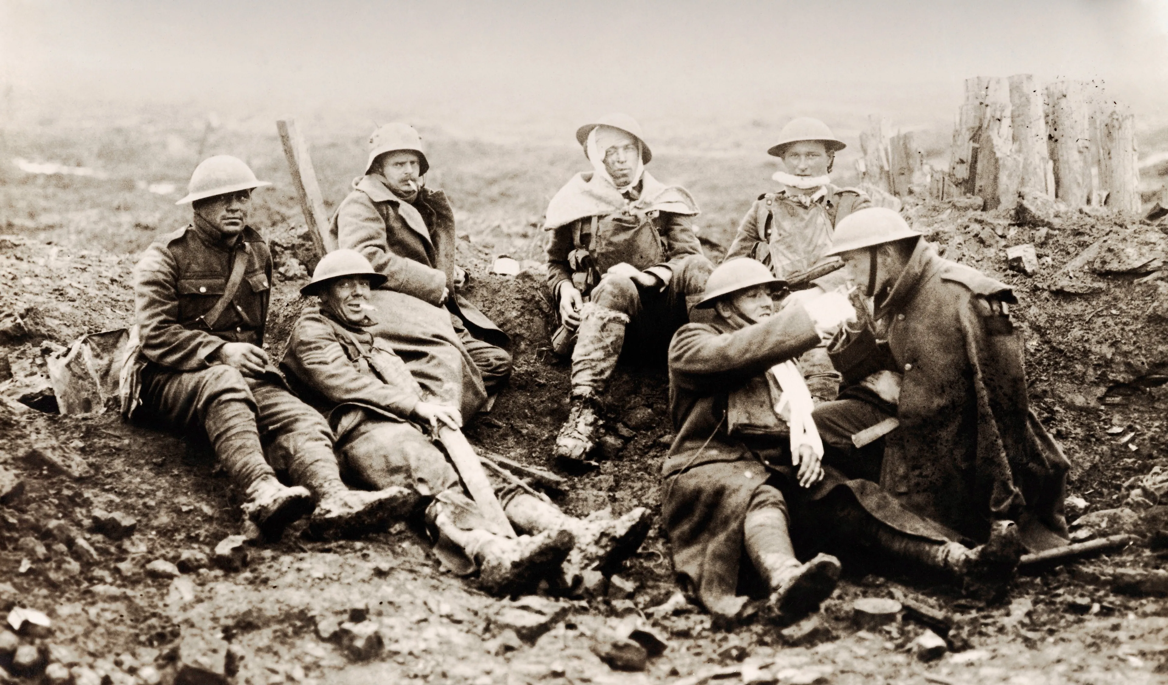 Wounded Canadian soldiers rest near a smashed German pill-box on the Western Front before moving on to a dressing station during World War One, circa 1916. (Popperfoto/Getty Images)