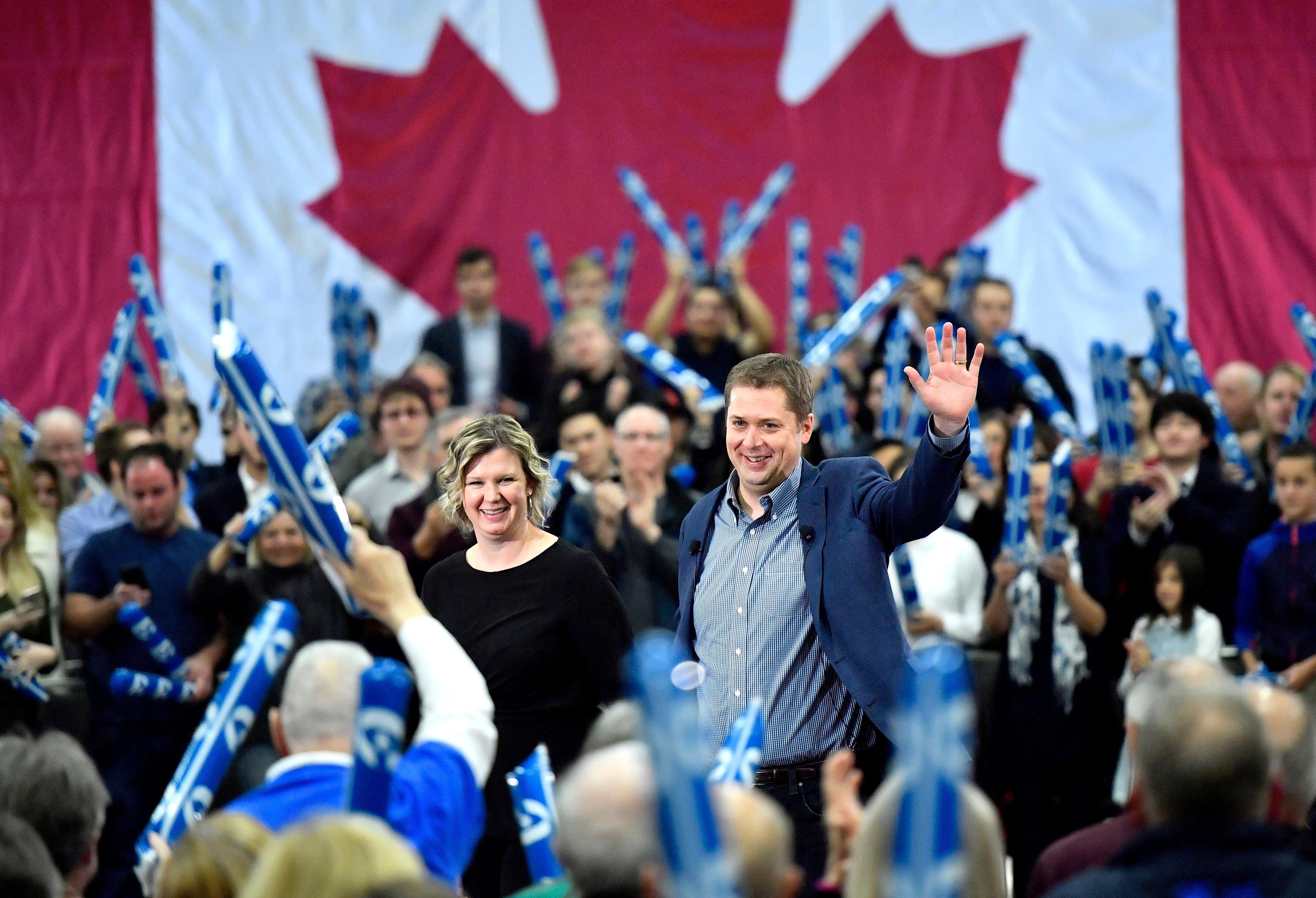 Conservative leader Andrew Scheer waves to supporters as his wife Jill joins him on stage, following a pre-election event in Ottawa on Sunday, Oct. 21, 2018. THE CANADIAN PRESS/Justin Tang