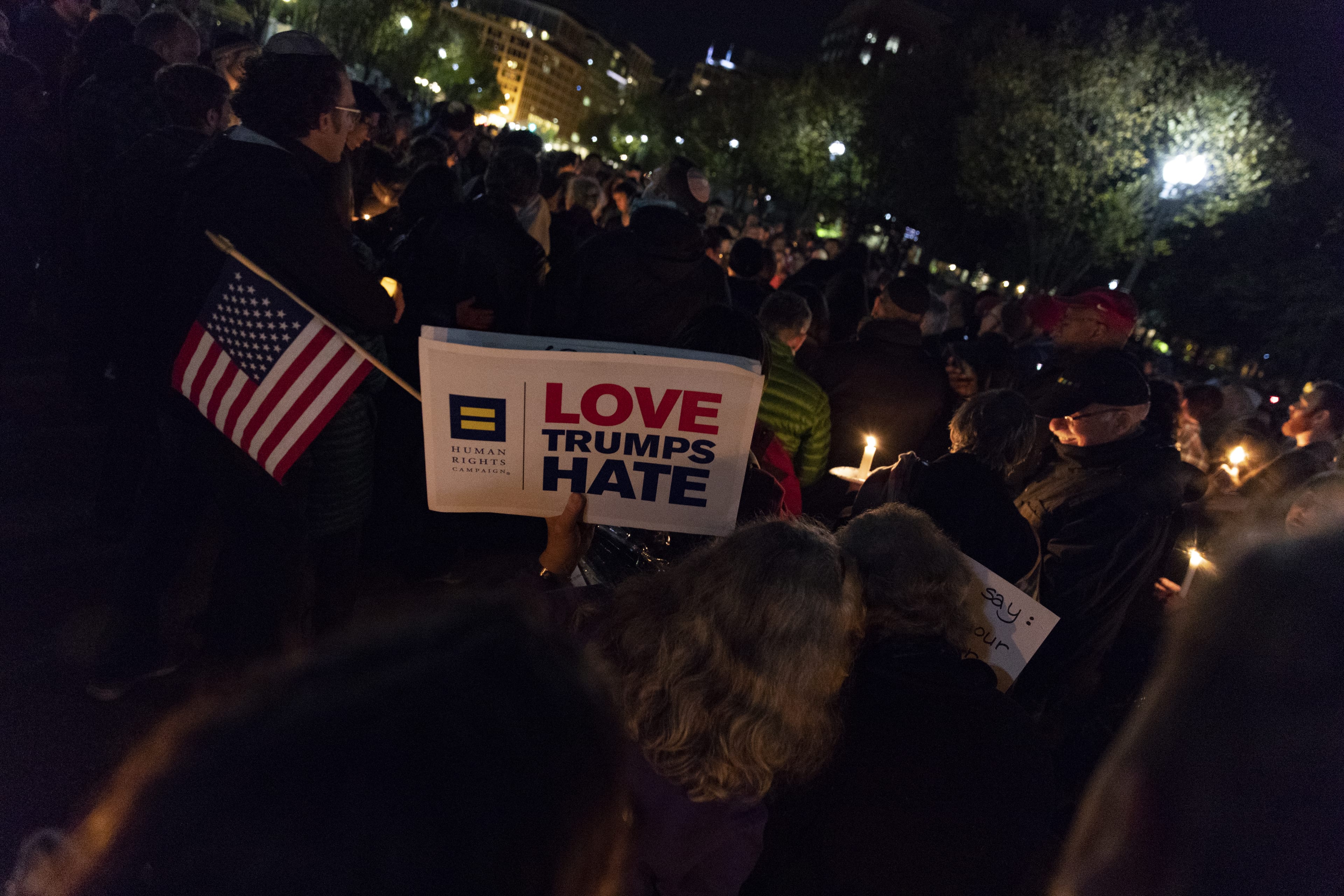 A vigil participant holds a 'Love Trumps Hate' sign during a Havdalah vigil for the victims of the Tree of Life Congregation shooting in front of the White House on October 27, 2018 in Washington, D.C. (Alex Edelman/Getty Images)