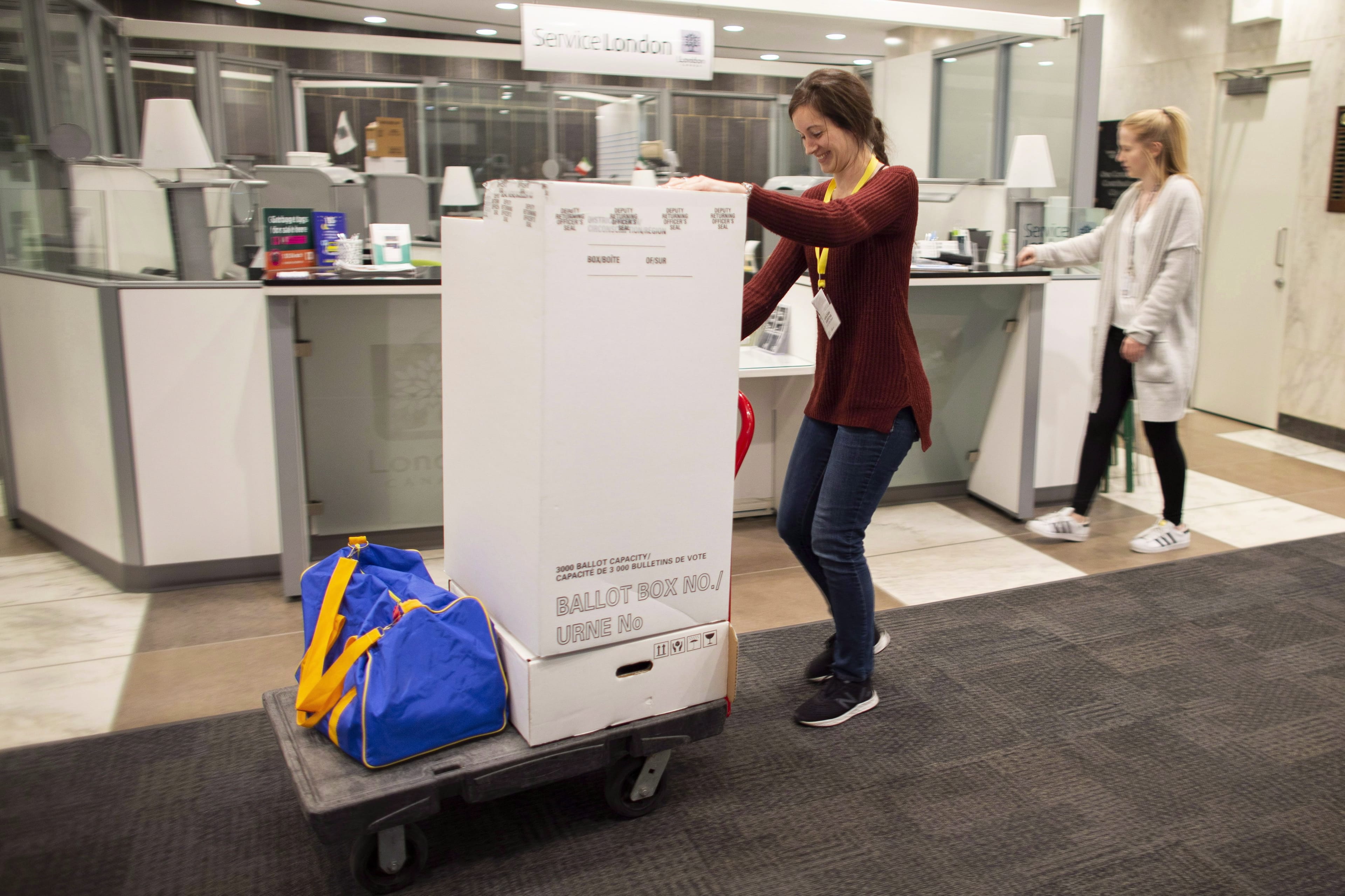 Election workers unload ballot boxes at City Hall in London, Ont., on Oct. 22, 2018. (Geoff Robins/CP)
