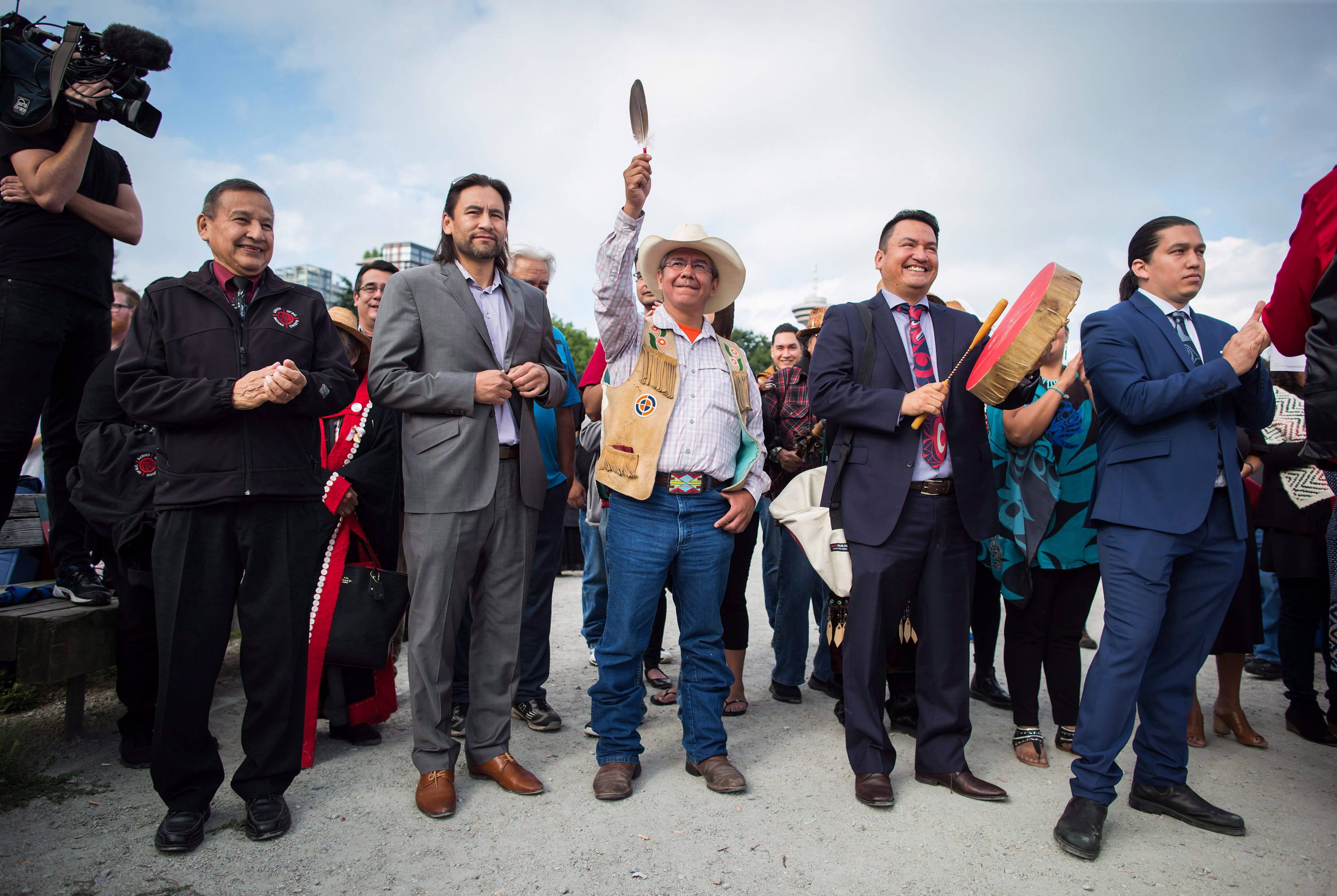Coldwater Indian band Chief Lee Spahan, centre, raises an eagle feather before he and other First Nations leaders respond to a Federal Court of Appeal ruling on the Kinder Morgan Trans Mountain Pipeline expansion, during a news conference in Vancouver, on Thursday August 30, 2018. In a unanimous decision by a panel of three judges, the court says the National Energy Board's review of the project was so flawed that the federal government could not rely on it as a basis for its decision to approve the expansion. (Darryl Dyck/CP)