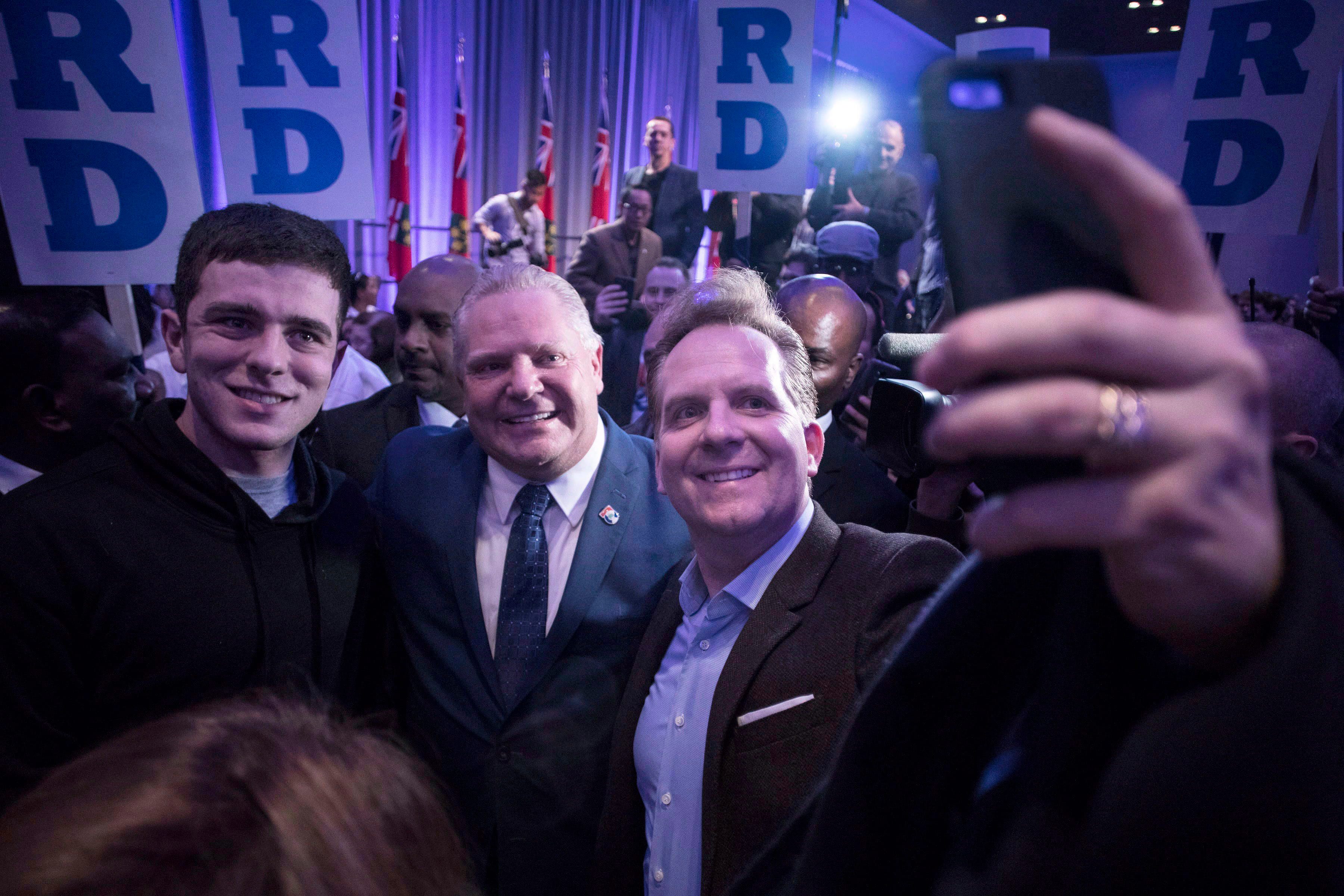 Ontario PC Leadership candidate Doug Ford, centre, poses for a selfie with supporters as he holds a campaign rally in Toronto on Saturday, February 3, 2018. (Chris Young/CP)