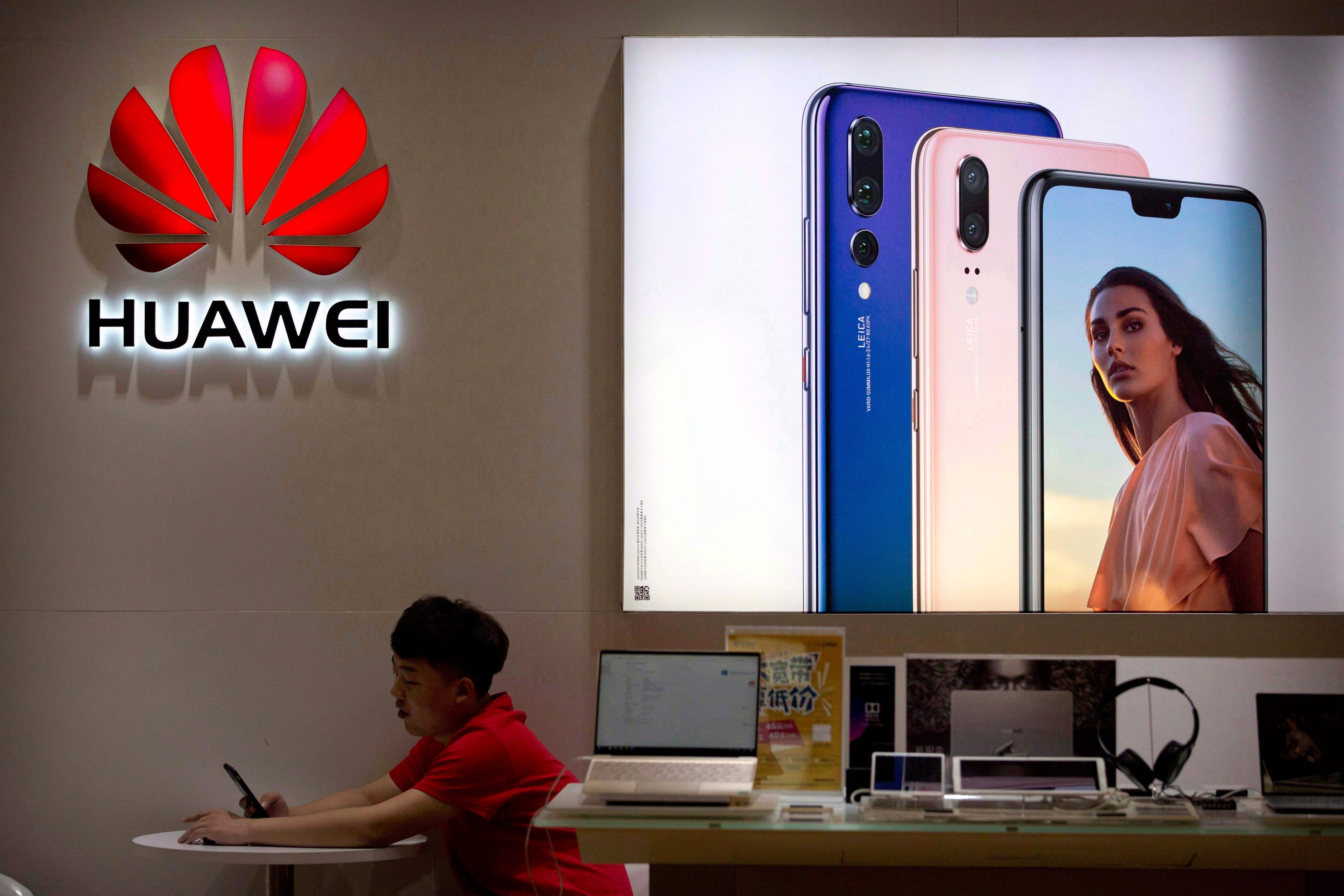 A sales clerk in a Huawei store at a shopping mall in Beijing. Allowing Chinese firm Huawei Technologies to build Canada's 5G wireless network could give Beijing backdoor access to revealing data about Canadians, security analysts warn. THE CANADIAN PRESS/AP-Mark Schiefelbein