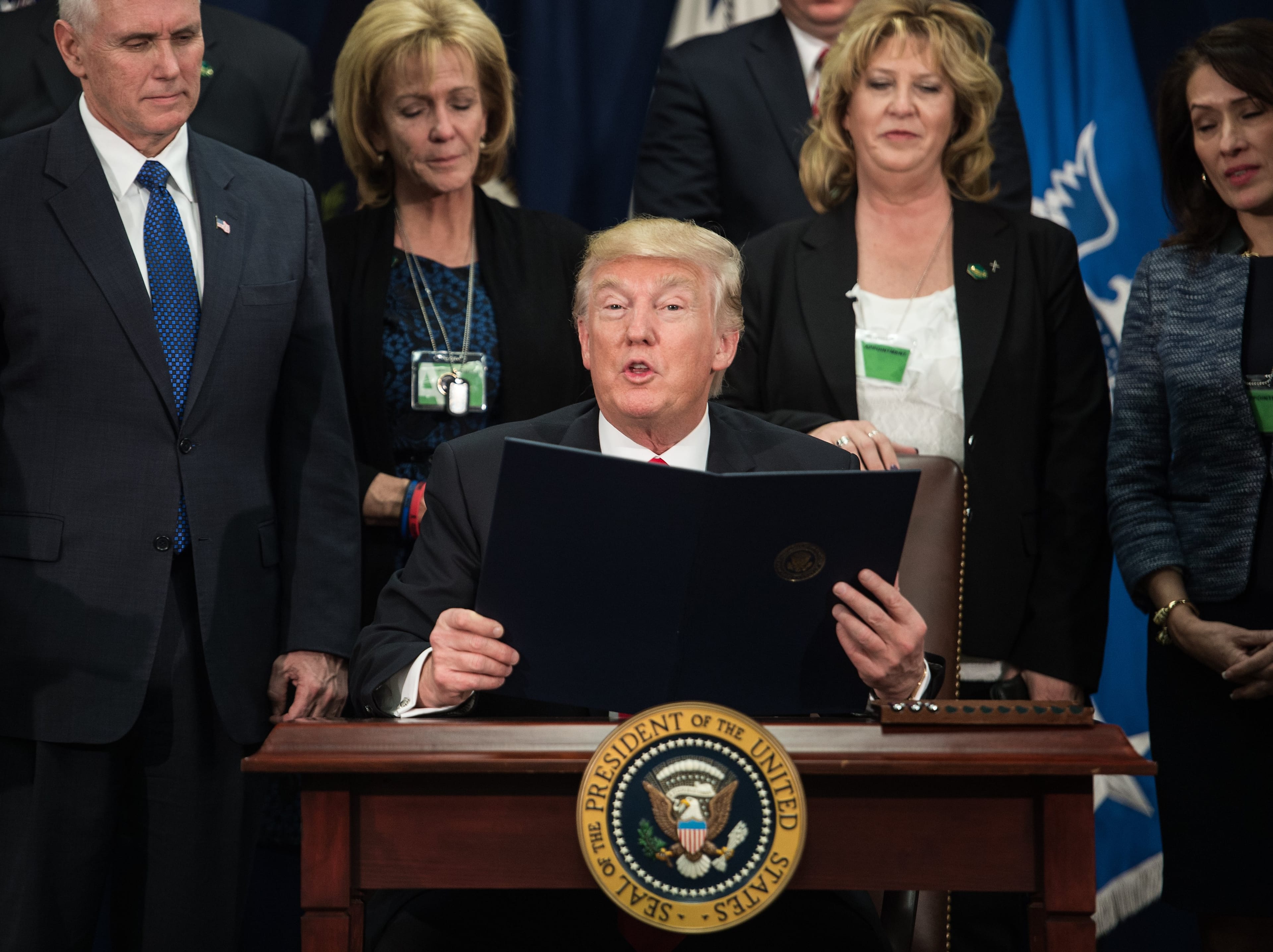 US President Donald Trump signs an executive order to start the Mexico border wall project at the Department of Homeland Security facility in Washington, DC, on January 25, 2017. (Nicholas Kamm/AFP/Getty Images)