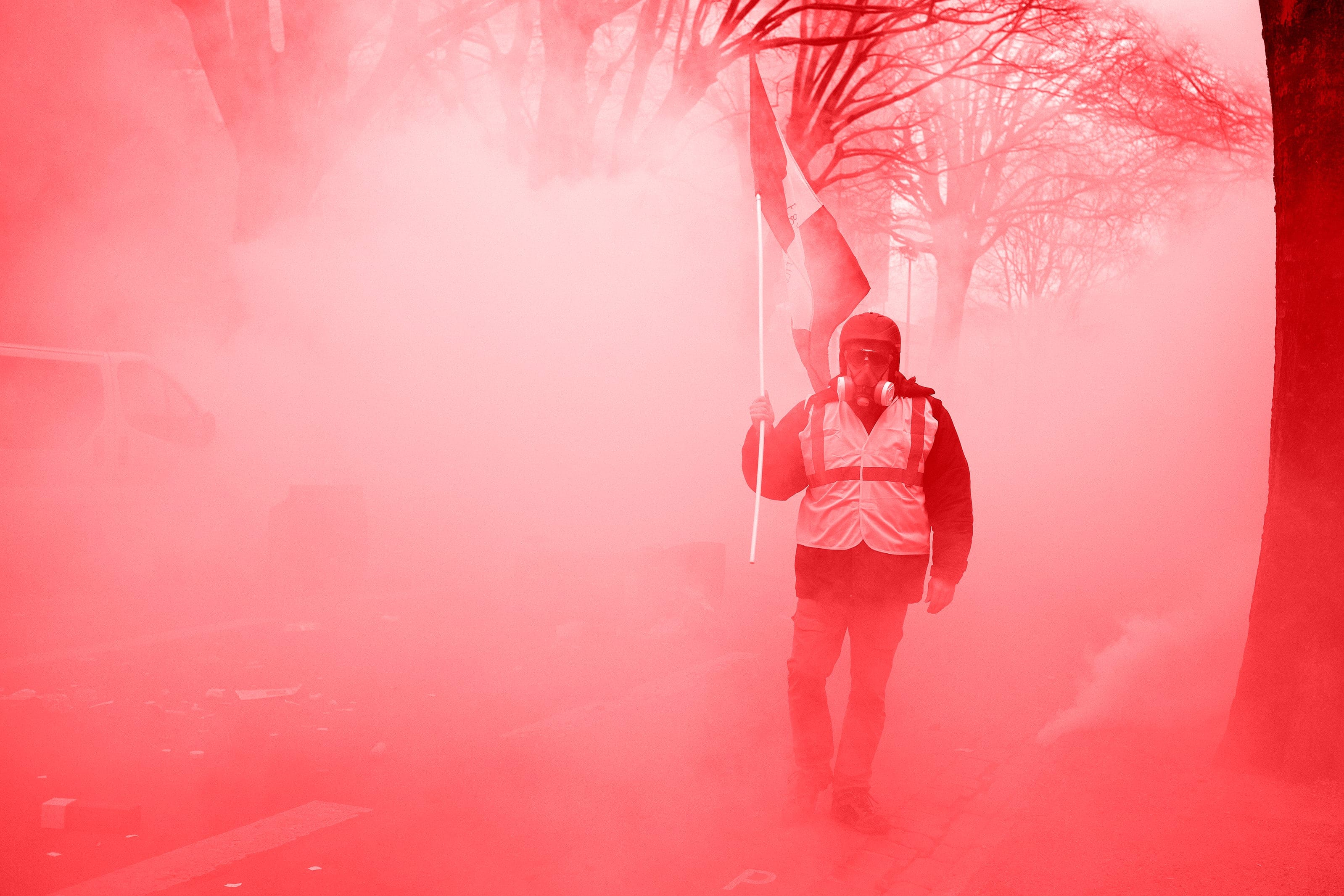 A Yellow Vest with a French flag walks amid clouds of tear gas in France on Dec. 29, 2018. (Alain Pitton/Getty Images)