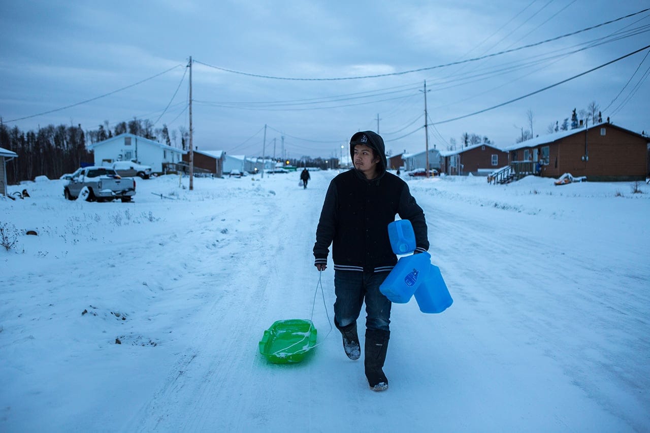 Several times a week, Ashley Sakanee would haul bottles down to the local hotel’s reverse-osmosis machine, just so his family could drink and bathe. (Photograph by Chris Donovan)