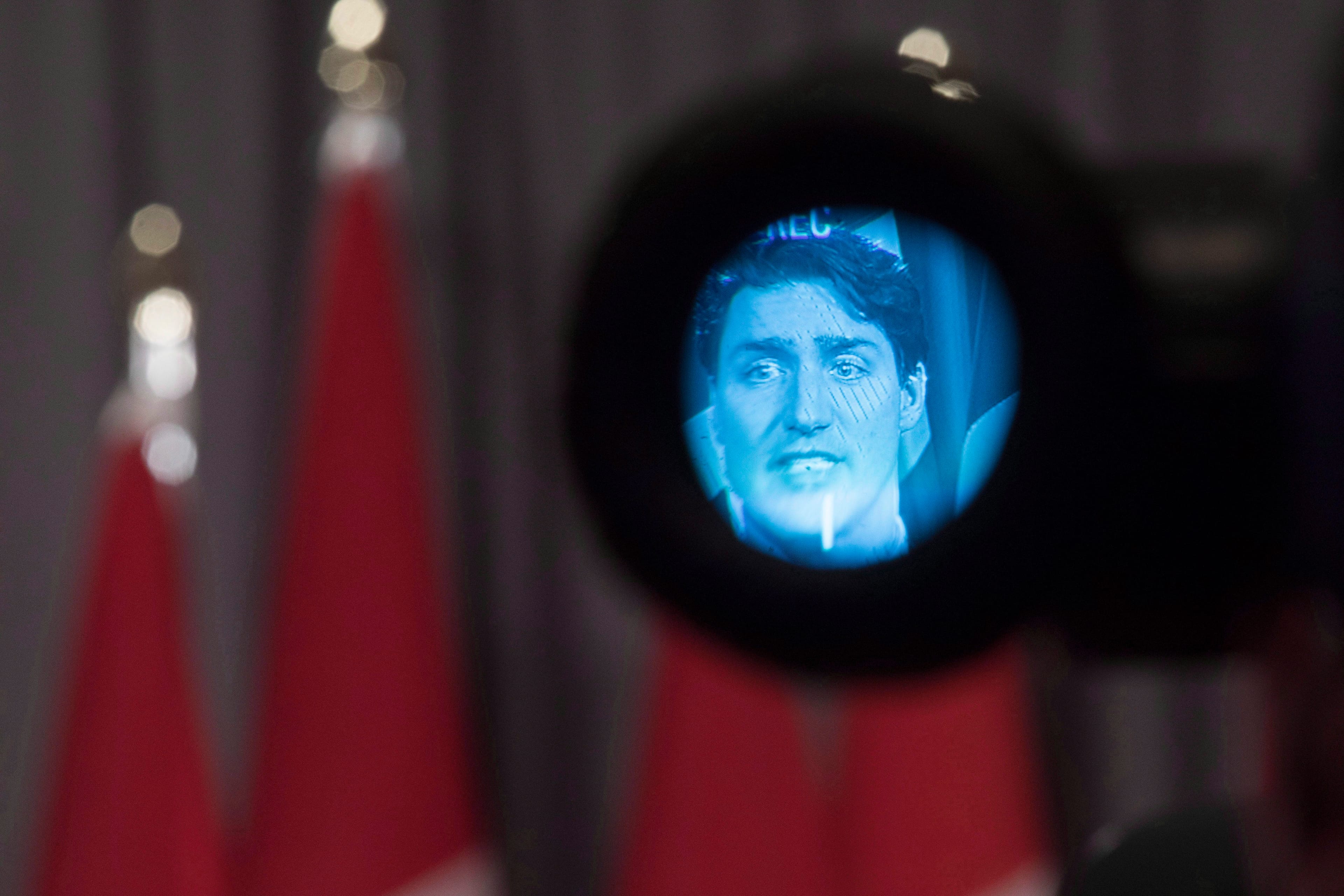 Canadian Prime Minister Justin Trudeau is pictured in the eyepiece of a television camera as he addresses the media following a summit meeting in Toronto with investors and members of the Canadian government, on Monday November 14 , 2016. THE CANADIAN PRESS/Chris Young