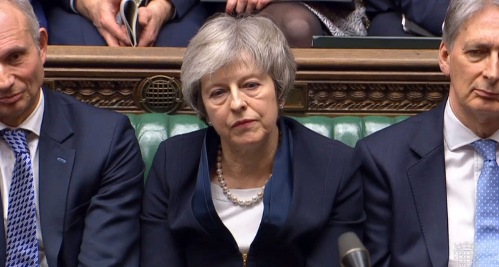 British Prime Minister Theresa May listens to Labour leader Jeremy Corbyn speaking after losing a vote on her Brexit deal, in the House of Commons, London, Tuesday Jan. 15, 2019. (House of Commons/PA via AP)