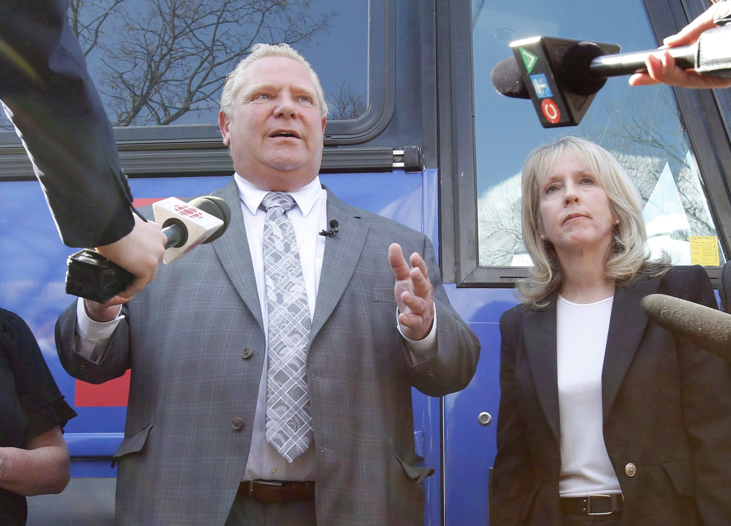 Ontario Progressive Conservative leader Doug Ford and Kanata-Carleton PC candidate Merrilee Fullerton speak to reporters a rally at Alice's Village Cafe as part of his Ontario provincial election campaign in Carp, Ontario on Wednesday, May 9, 2018. THE CANADIAN PRESS/ Patrick Doyle